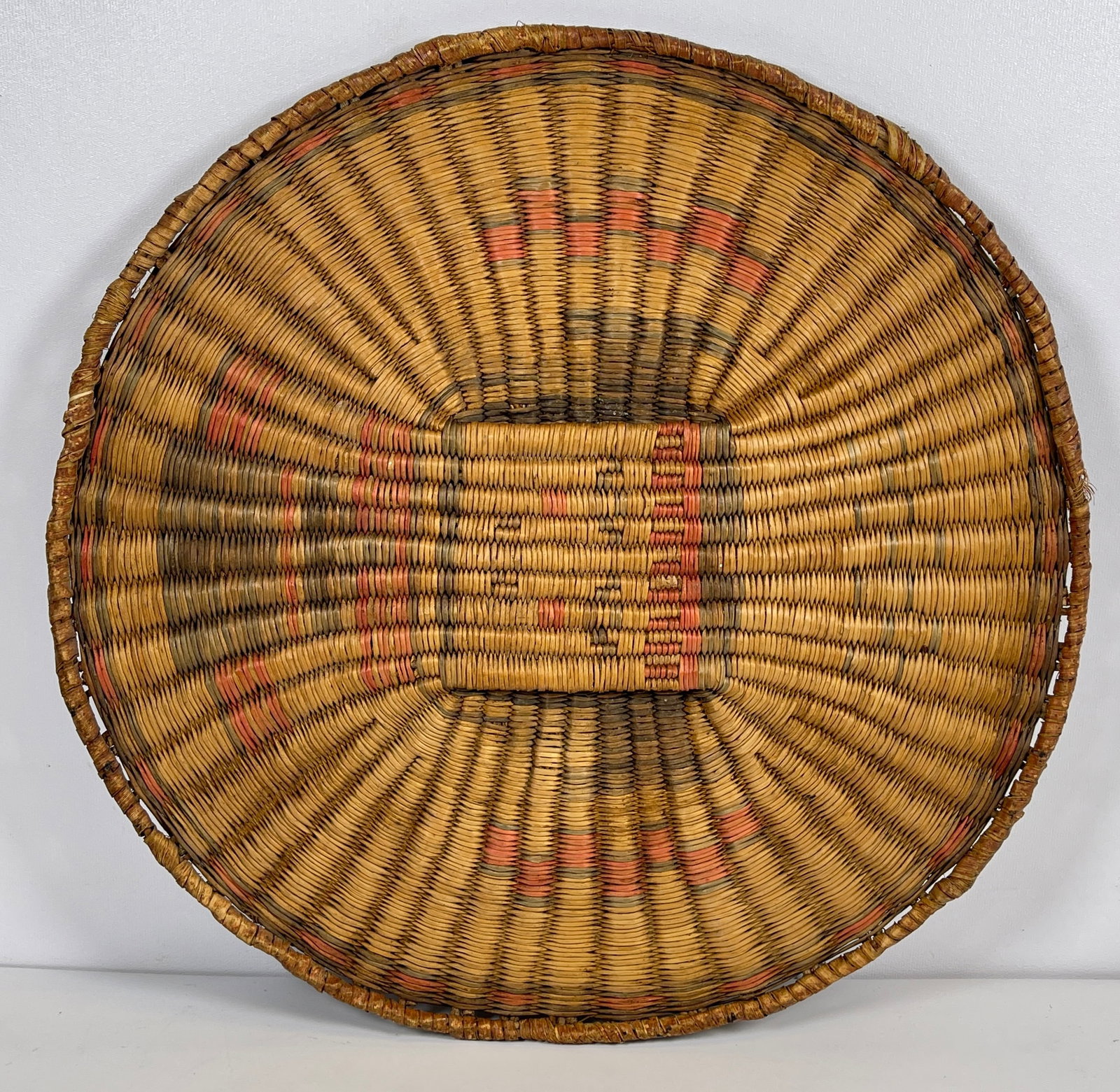 c1900 Hopi Oraibi Third Mesa Wicker Plaited Plaque: A wicker plaited plaque in rabbit brush with yucca rim, polychrome design. Weavers of the Hopi village of Oraibi (Third Mesa) are the only weavers in western North America to make baskets in this wick