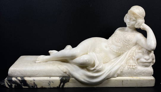 Guglielmo Pugi (Italian, 1850-1915) Marble Sculpture Reclining Woman: Woman reclining on a couch or bed, highly ornate details. Sits atop black and white marble base. Overall very good condition, some light scuffs and scratches to marble. Please see photos.