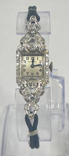 Art Deco Diamond & Platinum Ladies Wrist Watch 14k Clasp: Approx 1 carat total weight diamonds, with two .1875 carat diamonds. Watch is platinum, with a cloth band with 14k white gold ends. Hamilton movement. 18.5 grams inclusive. Measures approx 5.5 inches
