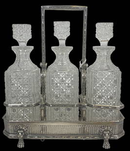 Antique English Tantalus Three Decanter Set: Antique English Tantalus Three Decanter Set, Silverplate caddy, movable etched handle and lion feet, with three cut glass matching stopper decanters Signed to bottom Elkington & Co. with hallmarks. Me
