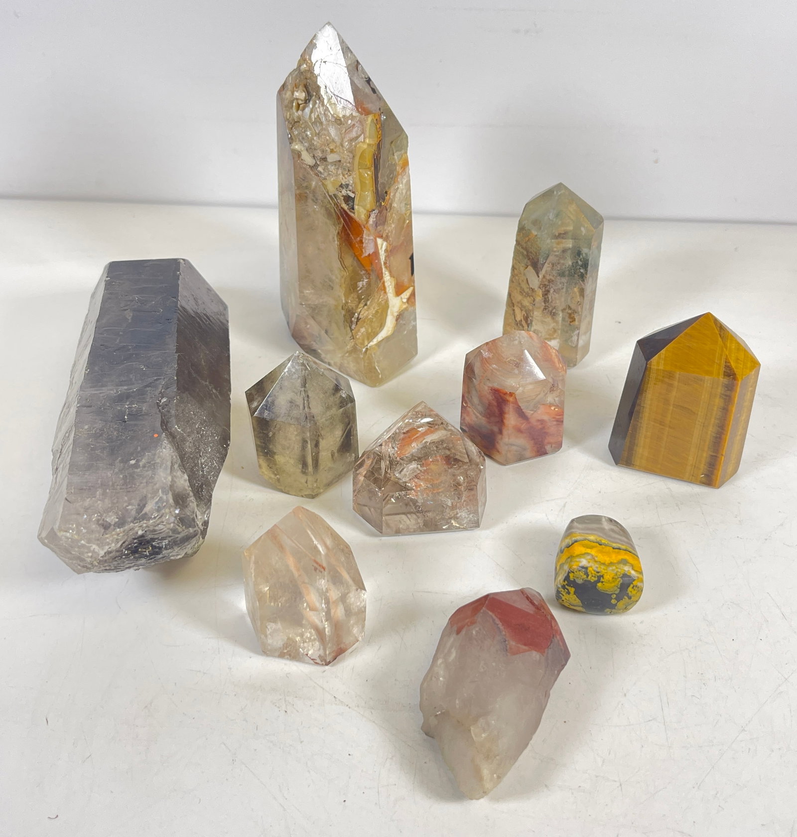 Lot of Obelisk Shape Minerals / Crystals: To include 10 obelisk shaped minerals, please see photos. Largest measures 6.125 inches high.