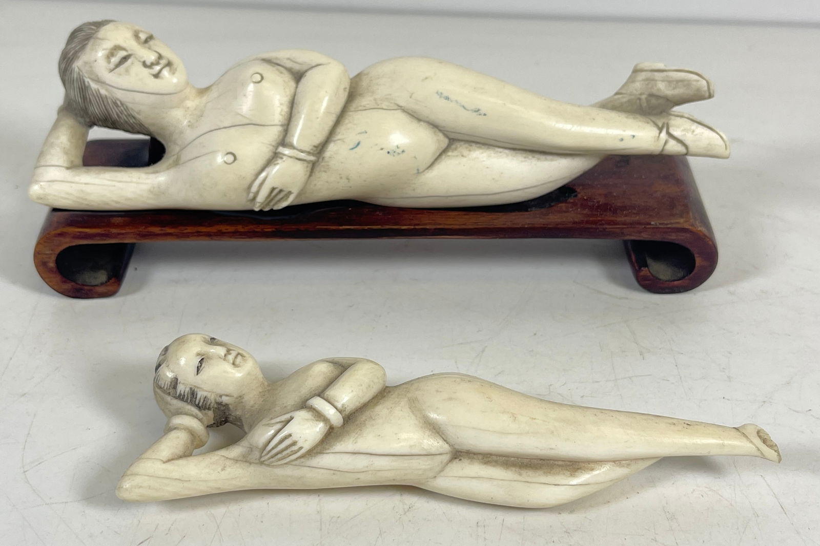 Lot of 2 Carved Bone Asian Doctors Doll: One on wooden stand, the other missing a foot. Longer one measures 6.25 inches long. Overall good condition, please see photos.