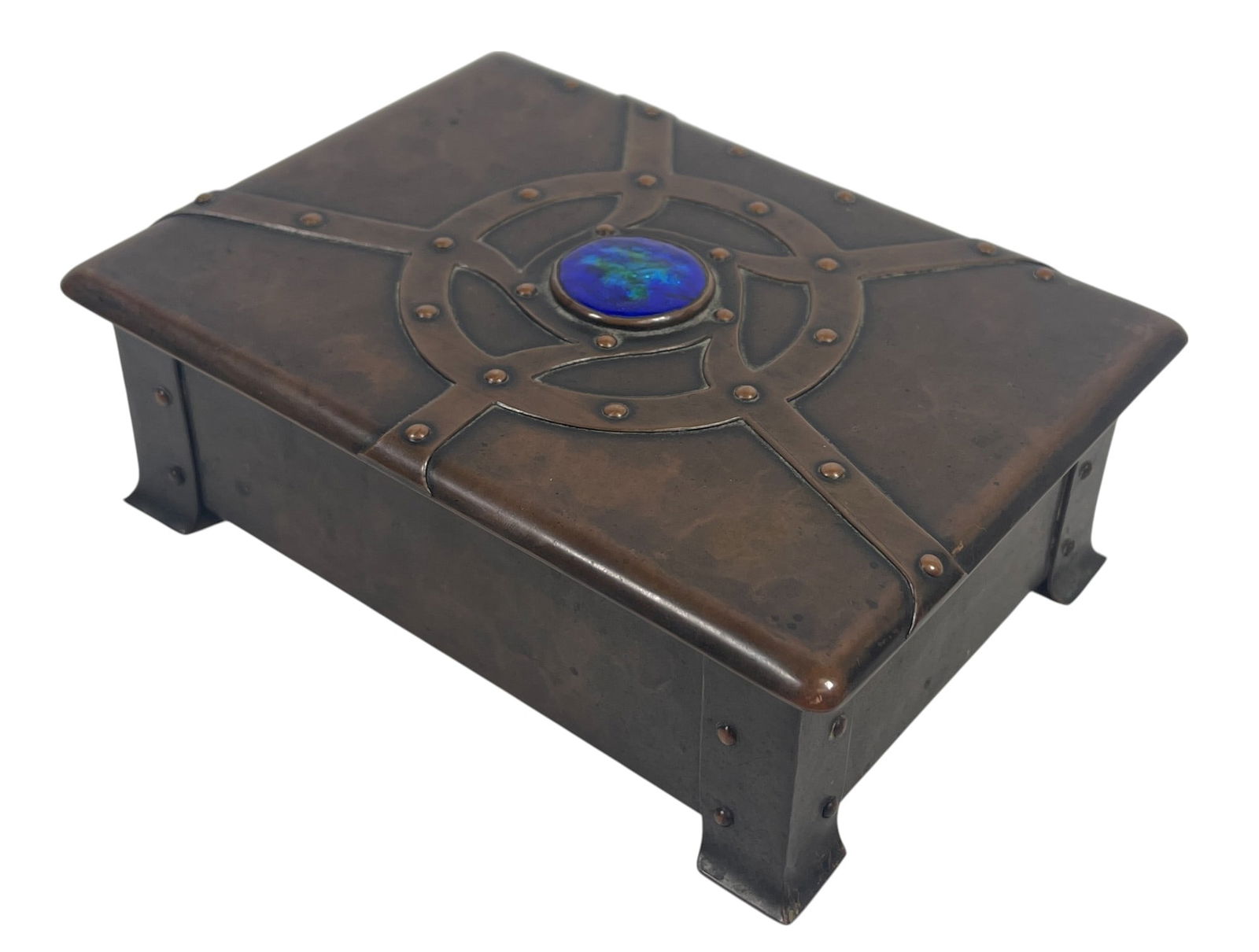 A.E. Jones Arts & Crafts Copper Casket: Riveted construction with a strap design on the lid, embellished with a enamel blue/green roundel. Box is lined with cedar. Box measures 2 inches high, 5.75 x 4.25 inches rectangular. Overall good con