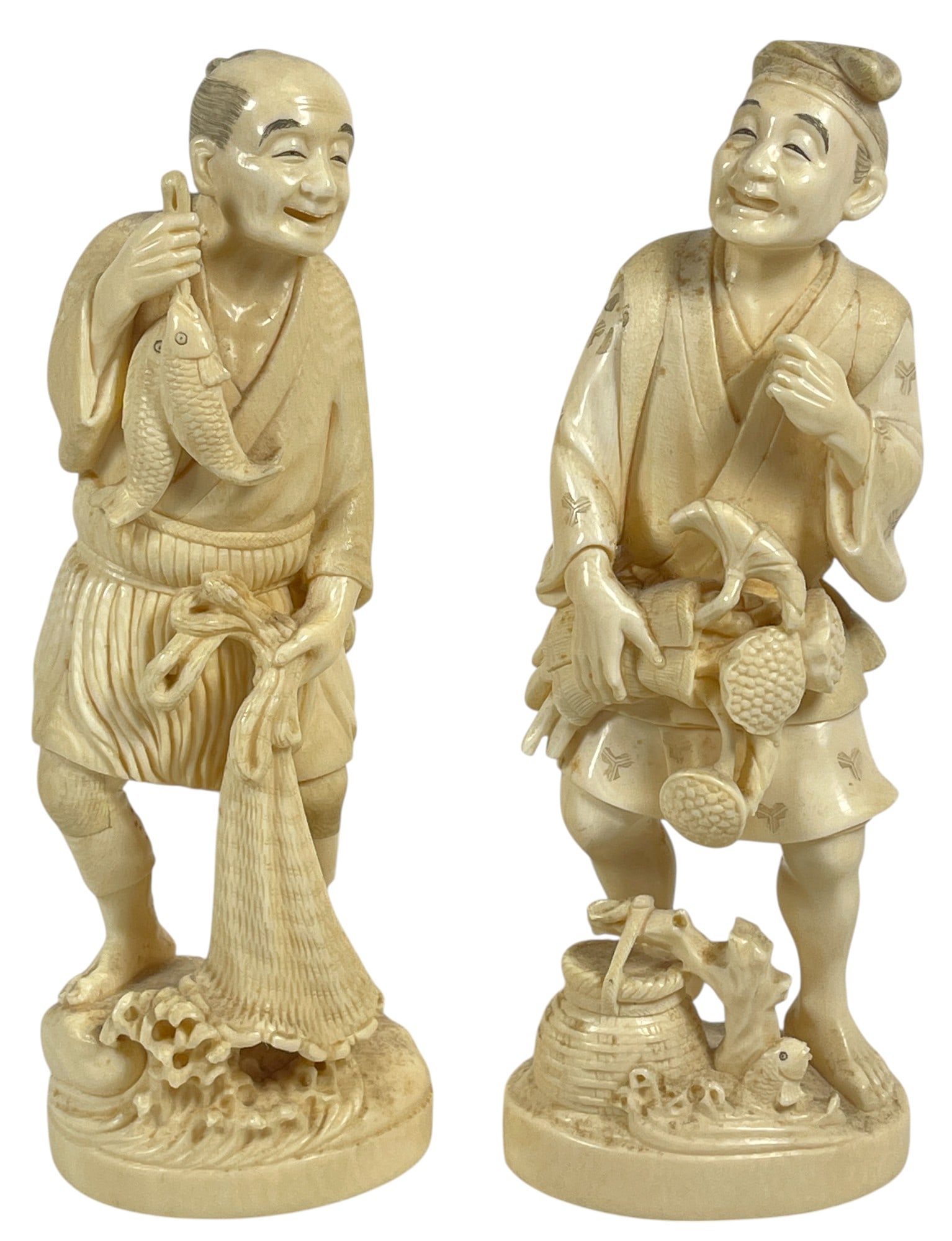 Pair Signed Meiji Period Asian Carved Bone Figures Okimono: One represents a fisherman holding a net and fish, the other a laborer carrynig a basket (appears to be missing something from his left hand). Measure approx 8.25 inches high, 2.75 inches wide. Overal