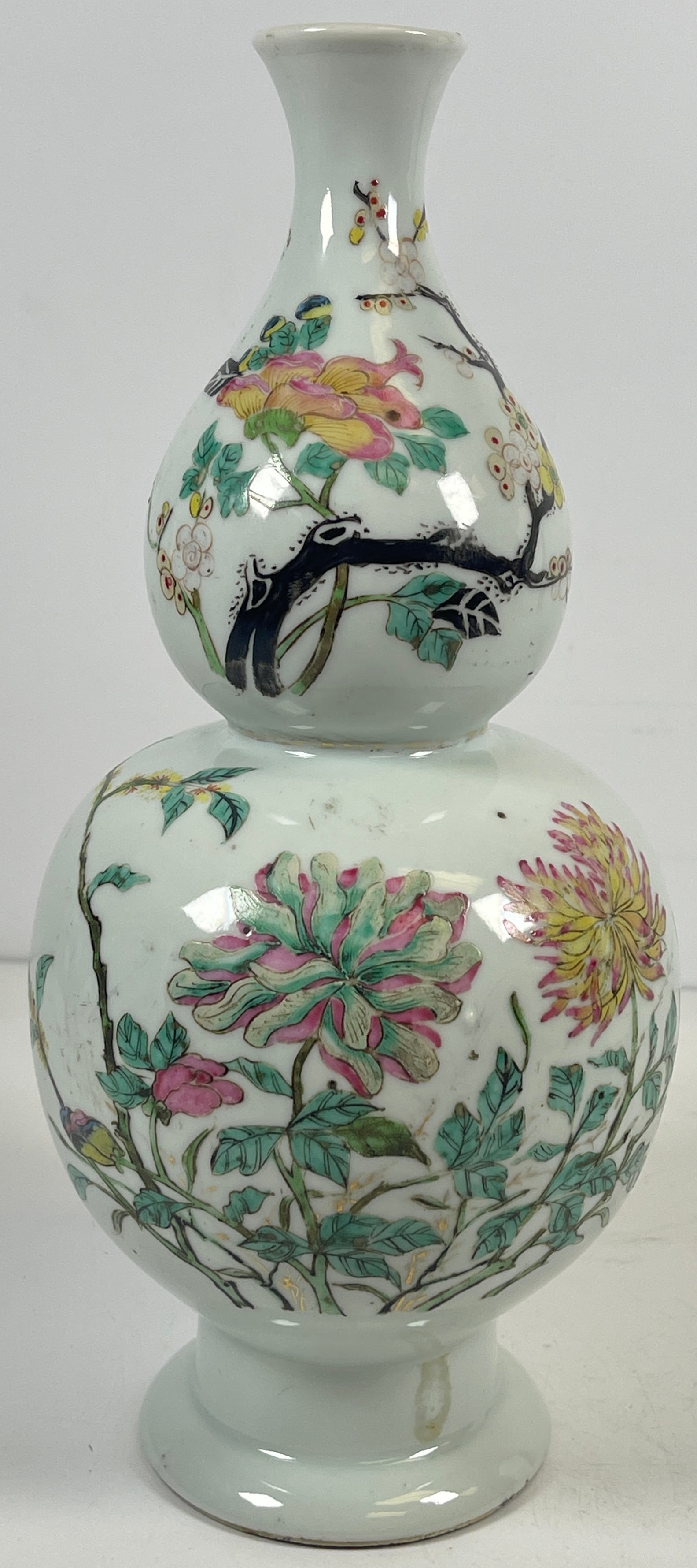 Antique Chinese Famille Rose Porcelain Vase: Unmarked. White ground with flowers. Measures 10.75 inches high, 4.75 inches at its widest. Overall good condition, no chips or cracks. Comes from an extensive collection of asian porcelain from a Man