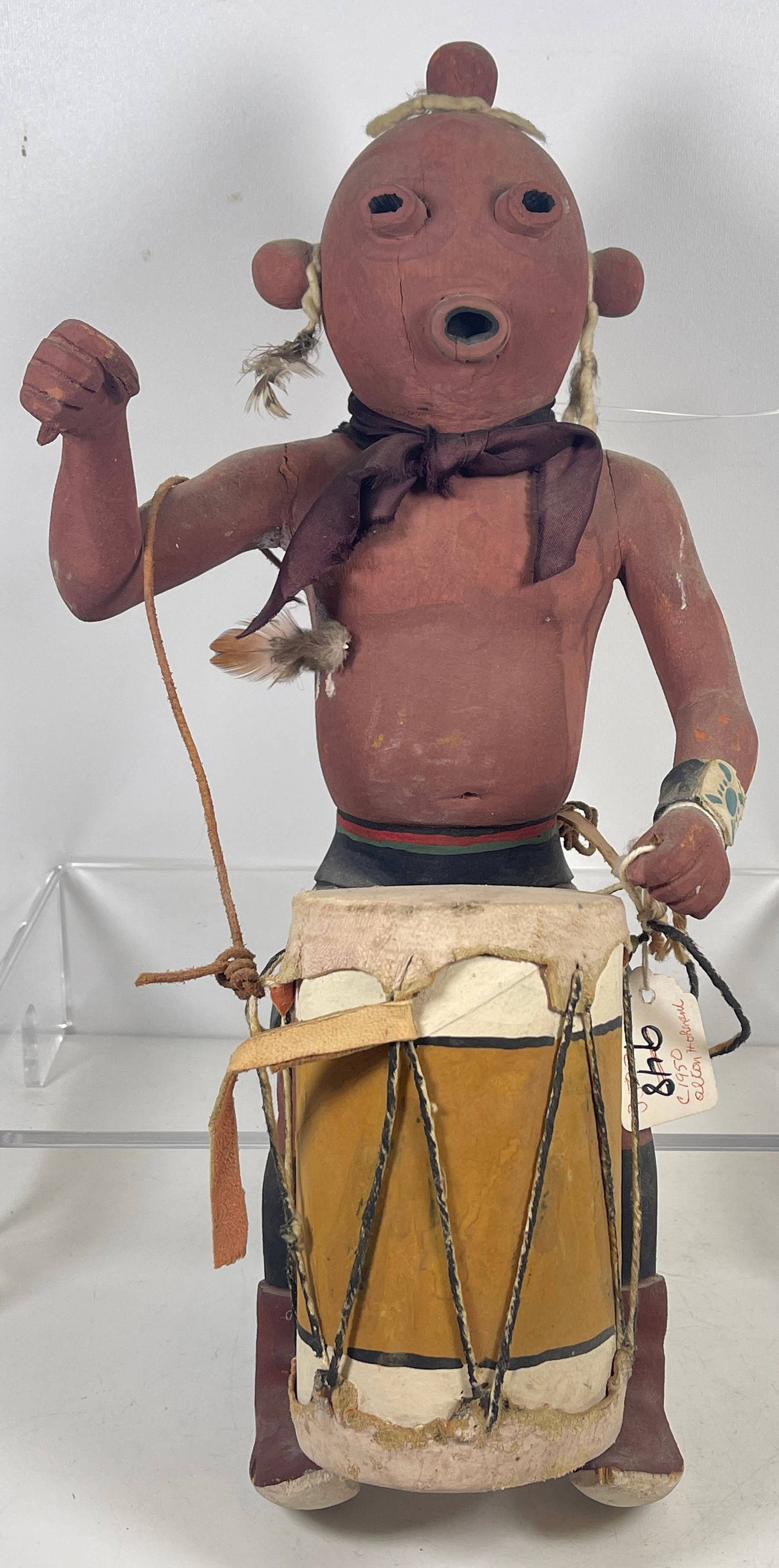 c1958 Hopi Mudhead Drummer Kachina by Alloh Hohnani: Has original auction listing and lot tag. Measures approx 16 inches high. Overall good/fair condition. Drumsticks absent, piece missing from back of head. Please see photos. Comes from a prolific coll