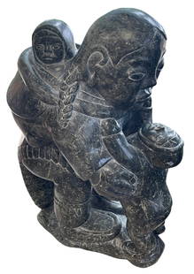 Large Inuit Soapstone Sculpture "Mother and Child" Johnny Inukpuk: Carved Inuit / Eskimo soapstone sculpture depicting a mother and child. Numbered to underside and appears to be signed in syllabics. Possibly Johnny Inukpuk. Measures 18 inches high, 12 inches x 8 inc