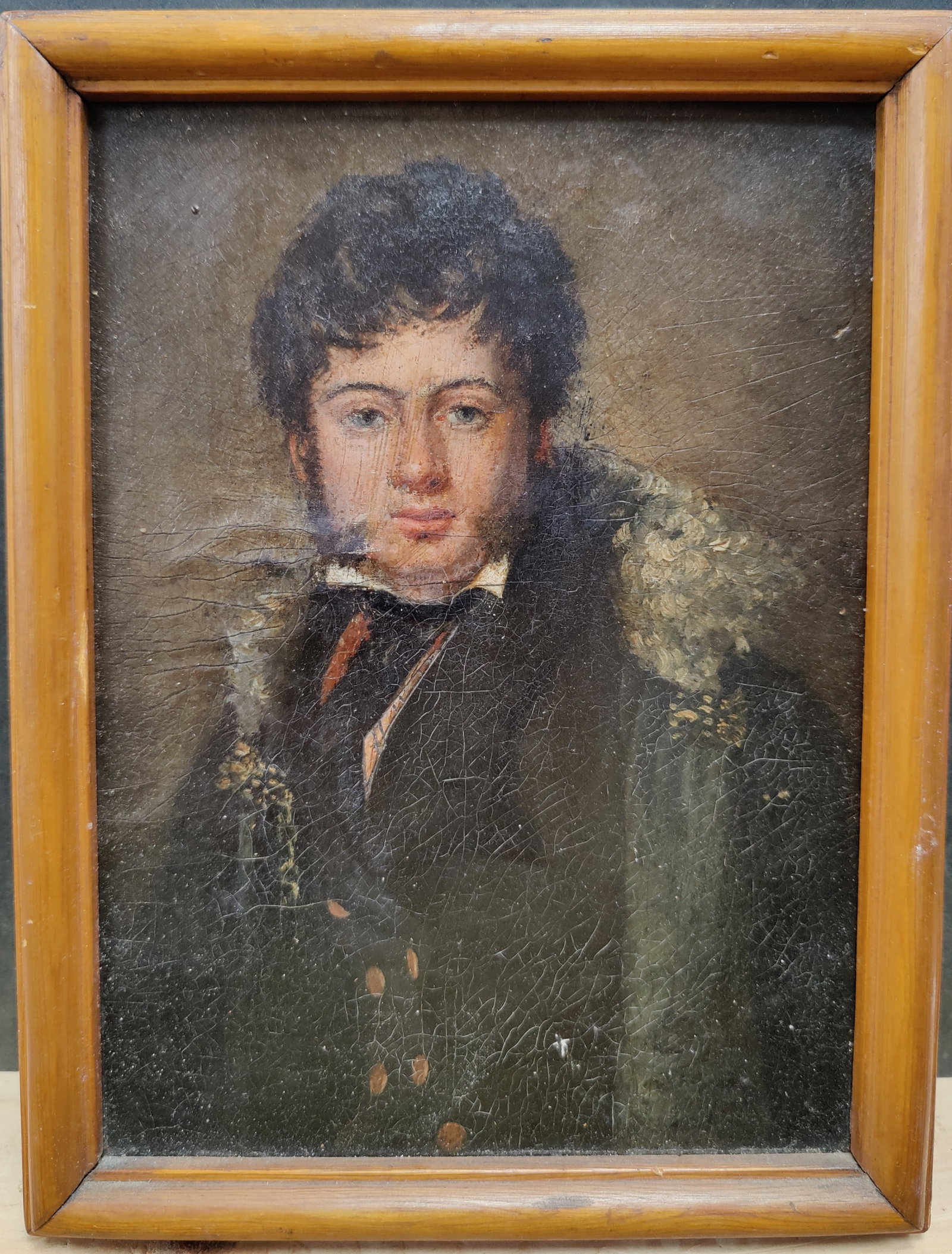 19th c. O/C Portrait of a Young Man in a Fur Collar Coat: O/C painting mounted to a board, in good condition, with dirt accumulation and craquelure. From a UES NYC Estate. 6" x 8.25" sight.