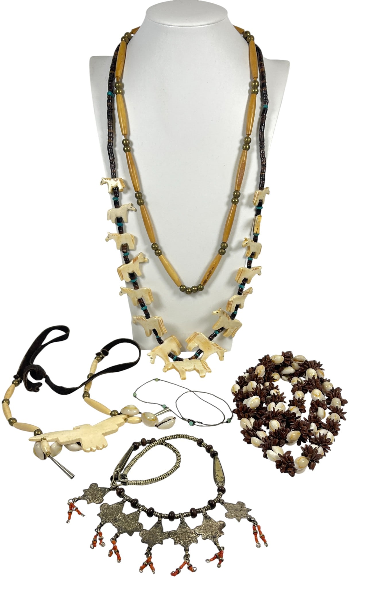 Lot of 6 Native American Necklaces inc Fetish & Bone: To consist of horse fetish necklace, eagle bone & shell necklace, another shell necklace, silver bead necklace, brown beaded necklace & beads and metal necklace. Please see photos