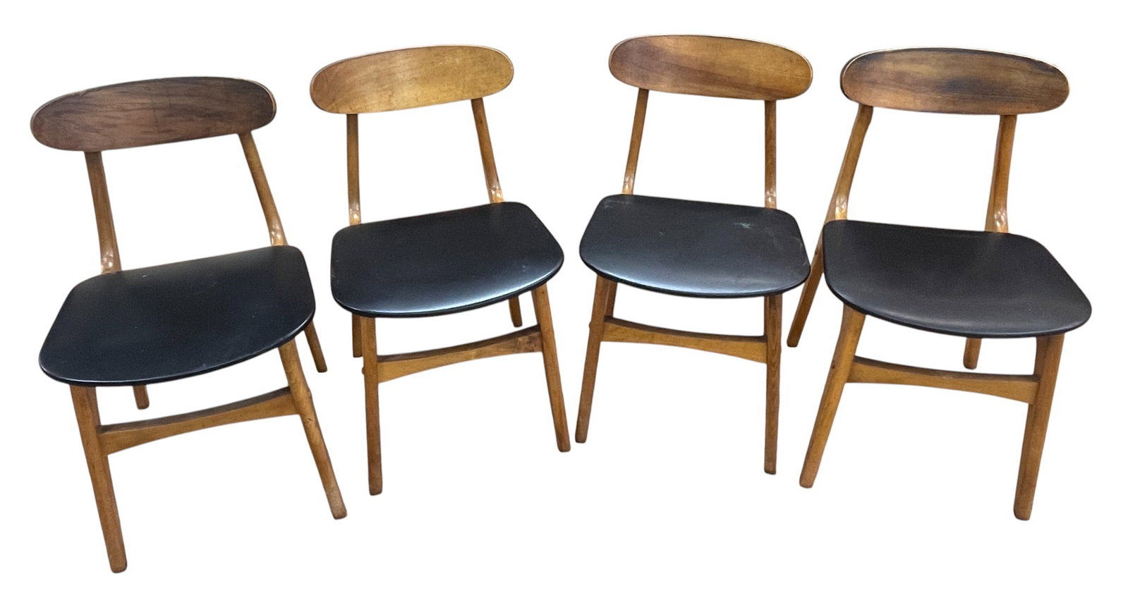 Set of (4) Danish Mid Century Dining Chairs: Set of four Danish Mid-Century dining chairs, with raised backs, black vinyl seats, supported on stretchered pin legs.Measure 30 inches high, 17.5 inches wide, 17.5 inches deep. Overall good/fair cond