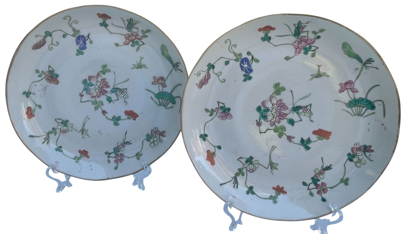 (2) Antique Qianlong Dynasty Famille Rose Floral & Insect Plates: Measure 9.5 inches in diameter and 1.5 inches high. Overall good condition, no other chips, cracks, breaks or repairs. Inspected with a UV light. Comes from an extensive collection of asian porcelain