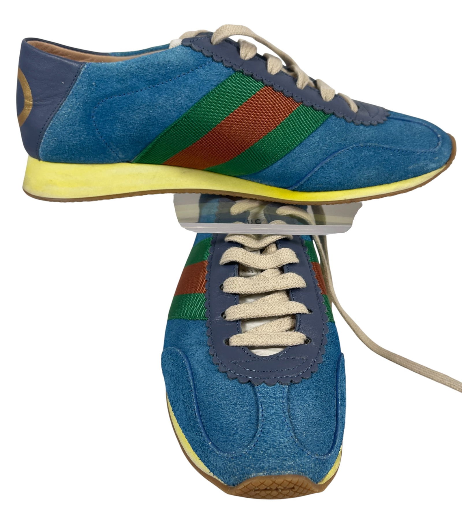Gucci Blue Rocket Suede Low Top Sneaker: From the 2018 Collection. Blue suede Gucci Rocket low-top sneakers with rubber soles, gold-tone foil-stamped logo at counters, scalloped leather trim at uppers and counters featuring lace-up closures