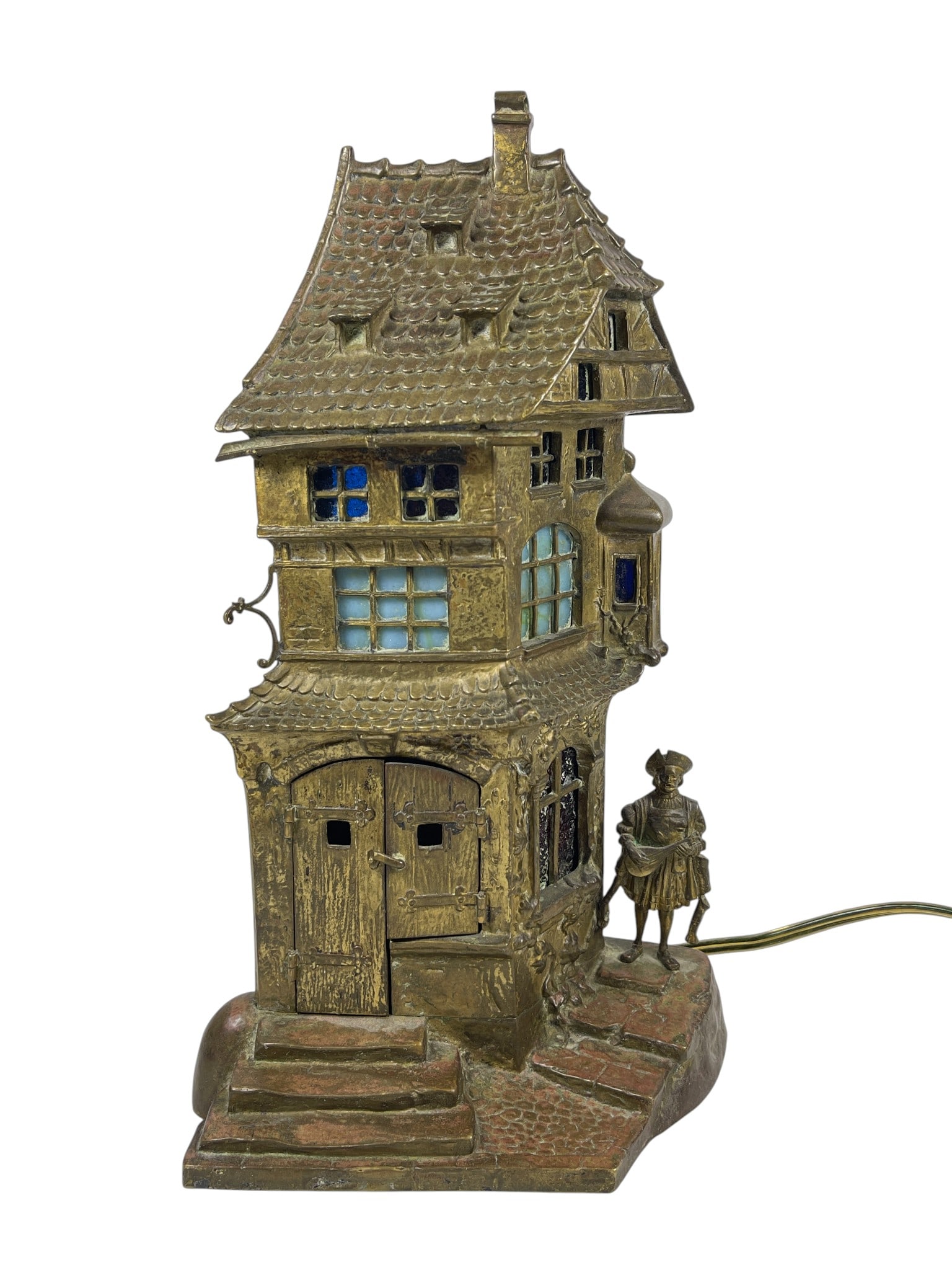 Franz Bergmann (1861-1936) Vienna Bronze Table Lamp 'Cobbler': Bronze, patinated, polychrome painting, green, red and blue stained glass. Austria, early 20th century. Design: Franz Xaver Bergmann (1861-1936) – Viennese bronze founder. Producer: Bronze foundry B