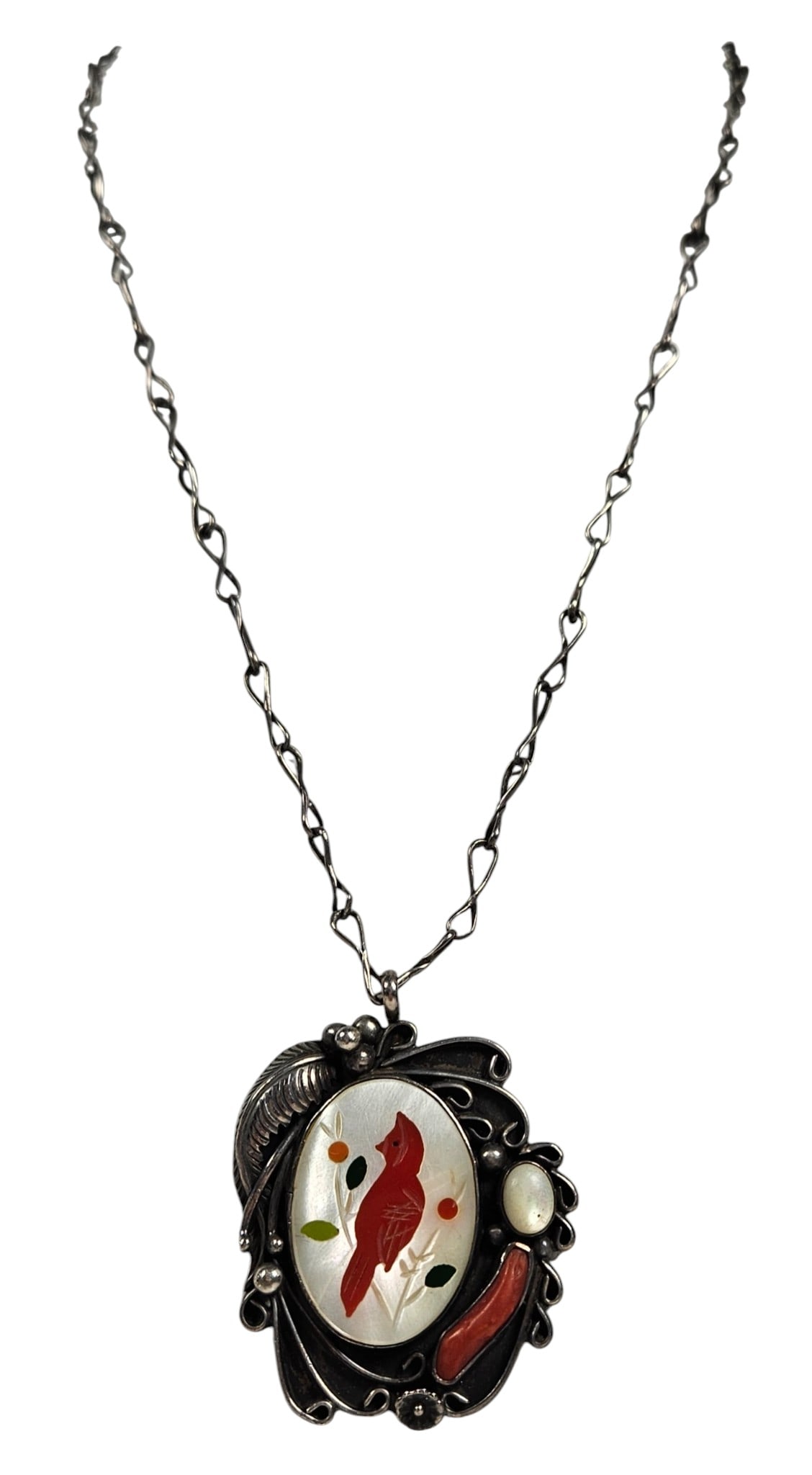 Vintage Native American Zuni Sterling Silver Cardinal Pendant Necklace: Coral cardinal set in MOP with what appears to be jade. Pendant measures 2 inches long to bale, chain measures just shy of 23 inches. Overall good condition, please see photos. Total weight 26.8