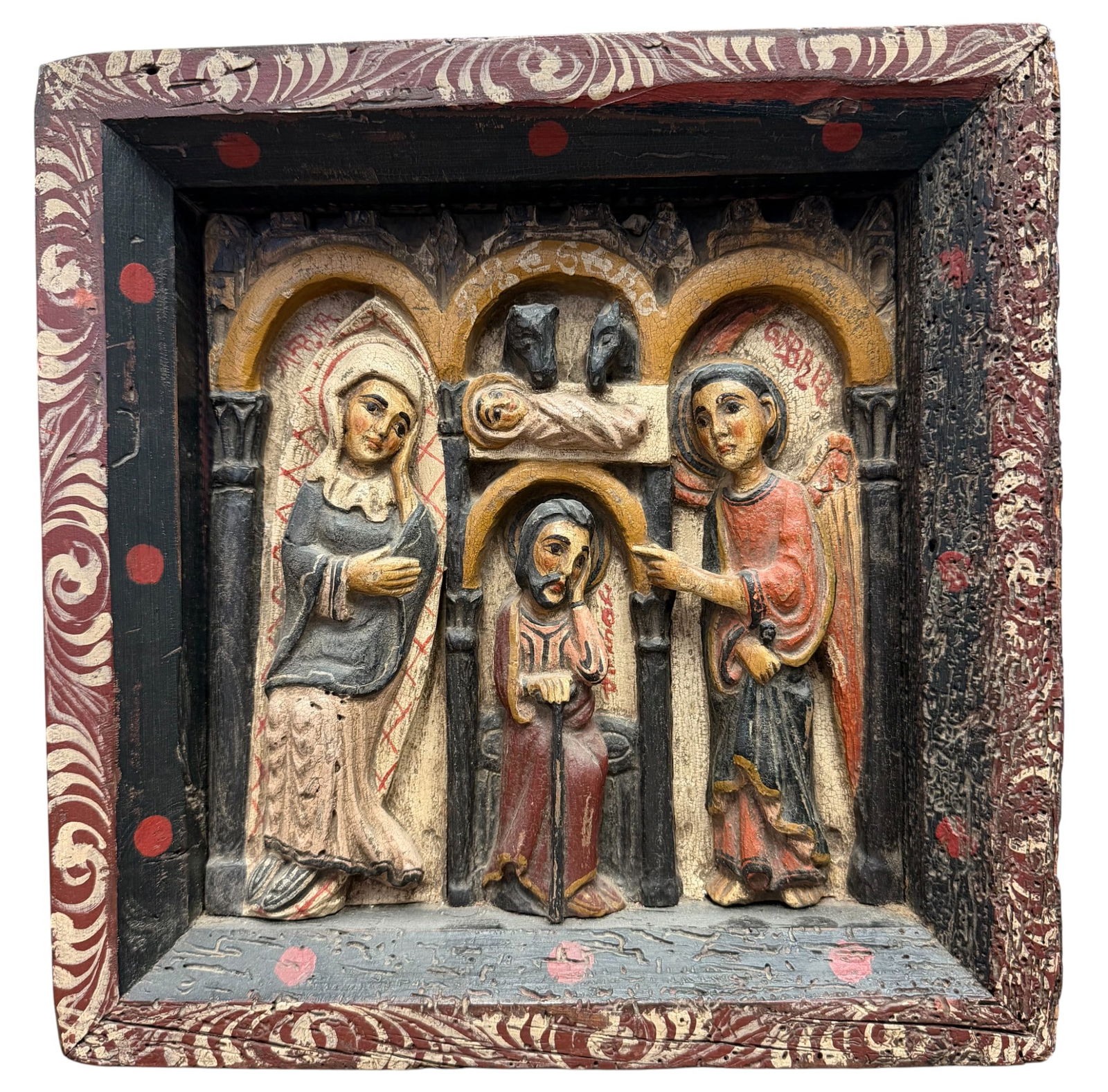 19th Century Polychrome Religious Folk Art Wooden Relief Panel: Scene appears to be the Nativity, or Adoration of the Magi, featuring figures that resemble the virgin Mary, the Christ child, and an angel. Measures 13 inches high, 12.75 inches wide, 2.25 inches dee