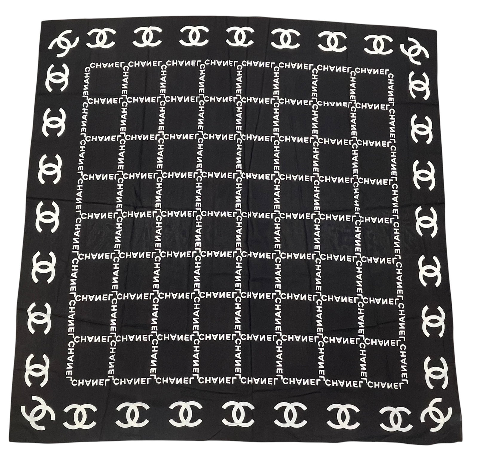 Vintage Large Chanel Black & White Cotton Scarf: Chanel black and white cotton large scarf, of square form, having a grid composed of the word Chanel, framed by a line of CC logo motifs, with rolled hem. Overall very good condition, comes with