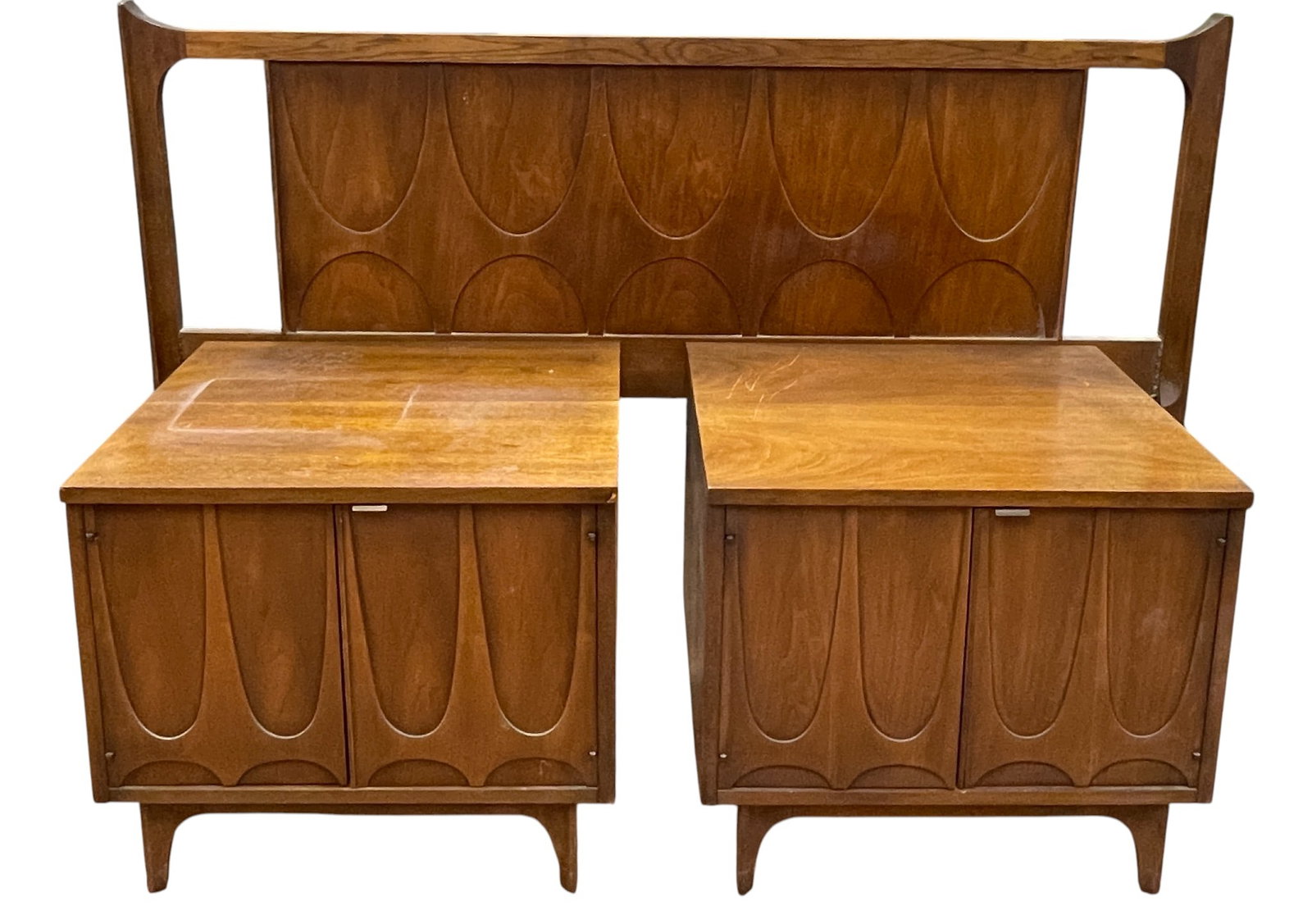 Pair Mid Century Broyhill Brasilia Walnut Night Stands & Headboard: Broyhill Brasilia. Walnut. Each nightstand has 2 doors. 21.125 inches high x 24 inches wide x 18 inches deep. Overall good condition, some surface scratches, one corner is chipped. Please see photos.