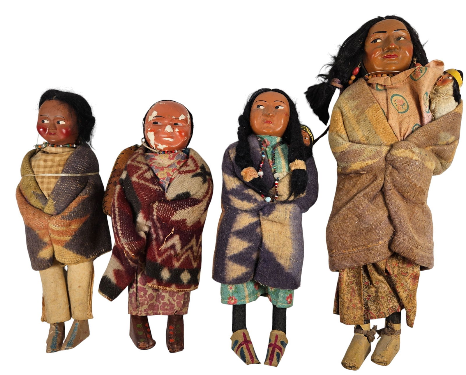 (4) Vintage 1920s Native American Skookum Dolls: To include father with child, mother with child, woman with child on her back, and another woman. Tallest measures approx 14.5 inches high. Overall good condition, please see photos.