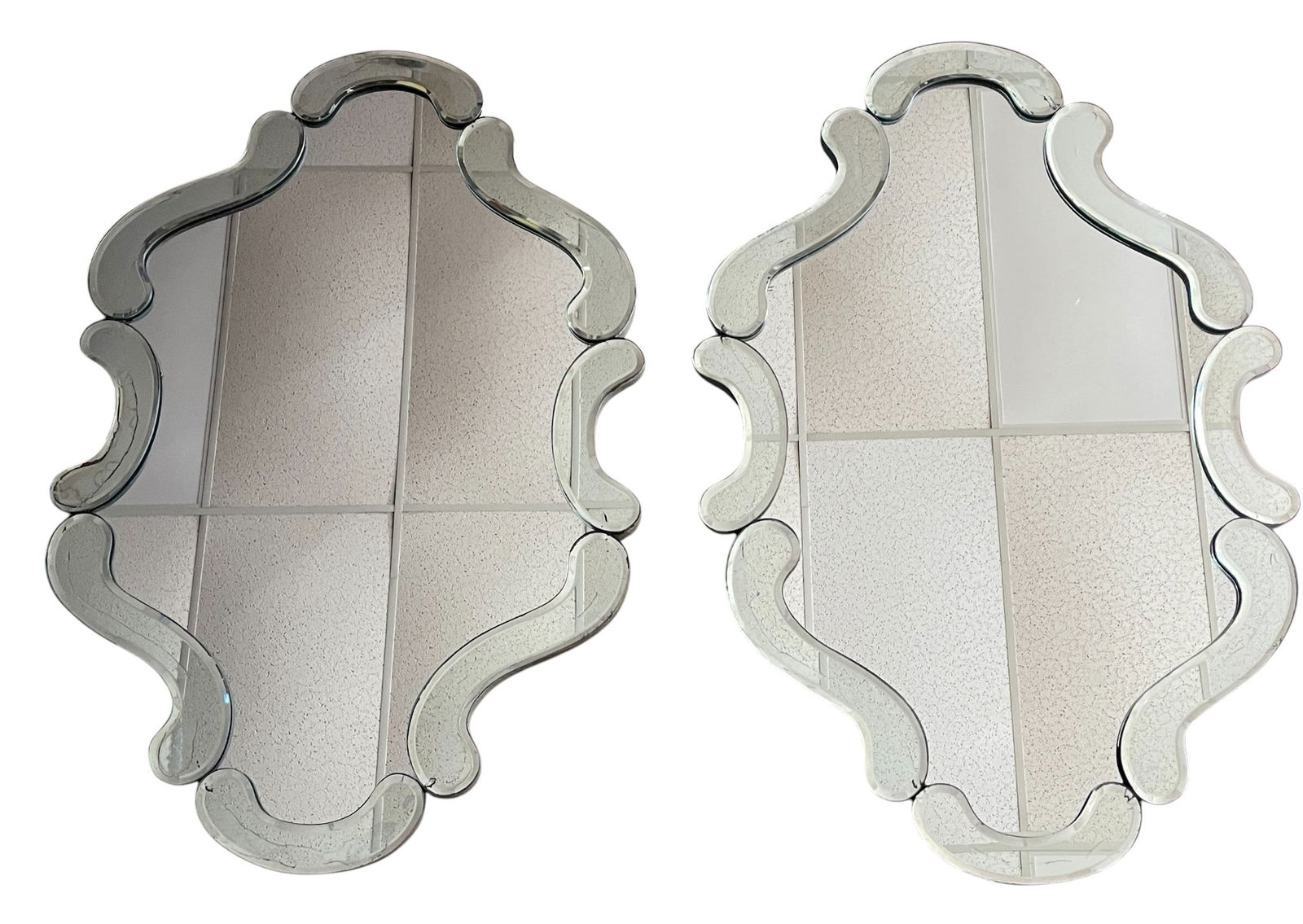 Pair c1940 Hollywood Regency Scalloped Edge Mirrors: Measures 39.5 inches high, 26.5 inches wide. Overall good condition, no chips to the glass - some discoloration to the silvering of the mirrors, please see photos.
