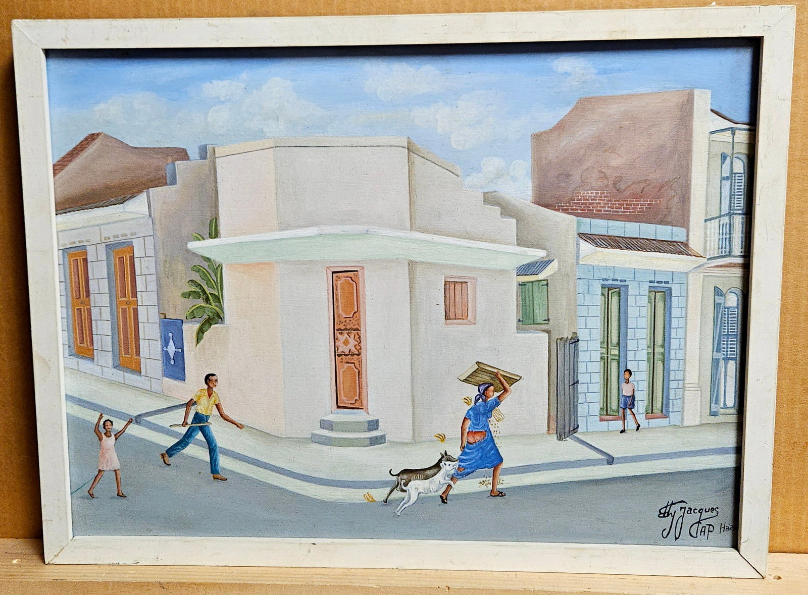 Eddy Jacques O/B Haitian Street Scene Painting: Eddy Jacques (Haiti, b. 1957 - ) O/B Haitian street scene in very good condition. White painted wood edge framing in good condition, with wear around the edges.