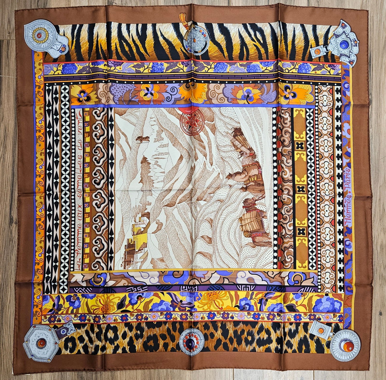 Hermes La Femme Aux Semelles de Vent Silk Scarf by Aline Honoré: Depicting the travels of Alexandra David-Néel, original design by Aline Honoré. Hand rolled edges. Never worn. Original box, tissue, and ribbon Included. 90cm x 90cm.