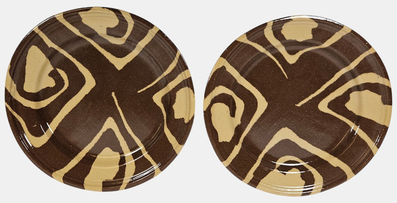 Pair Mid Century Jurg Lanzrein (Swiss, b 1951) Art Pottery Chargers: Features his signature 'ceramic inlay' technique, where different colors of clay are hand mixed and polished to create unique, high contrast organic designs. Chargers measure 10.375 inches in diameter