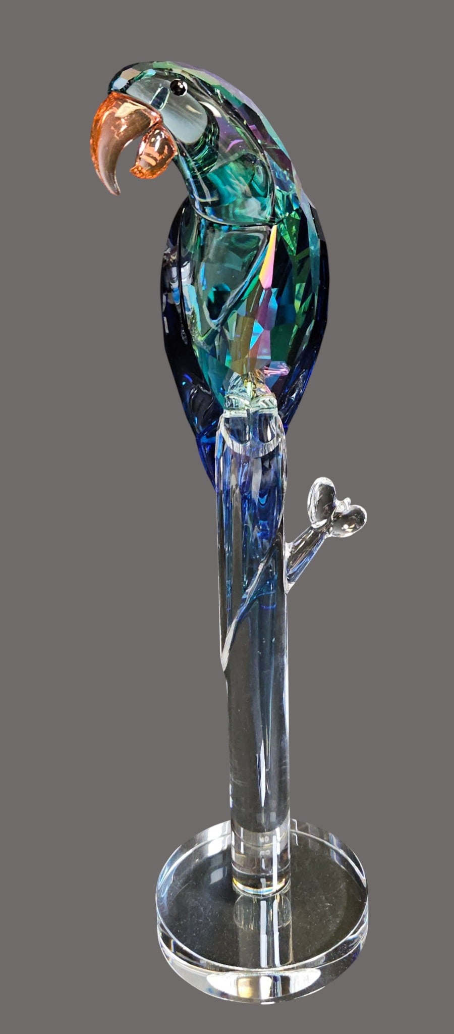 Swarovski Crystal Jungle Beats Green Macaw Banjo: # 5557849, 2021. This beautiful crystal creation captures the lively, playful nature of the Green Macaw, an endangered species found in the tropical forests of South America. Crafted entirely from