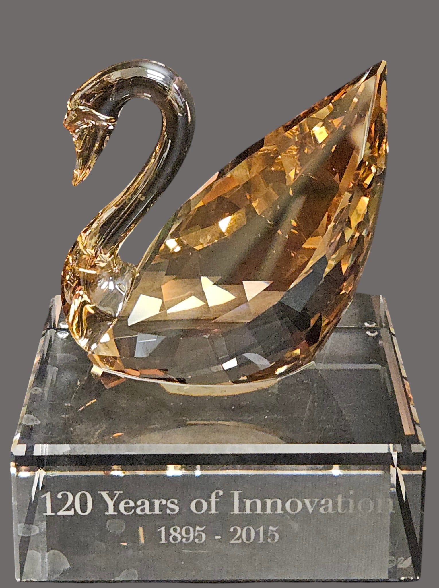 Swarovski SCS Crystal 2015 120th Anniversary Swan Event Piece: A contemporary interpretation of the swan, inspired by the Centenary Swan launched in 1995. An iconic design, Special engraving featuring the logo of Swarovski. Faceted clear Crystal with Golden