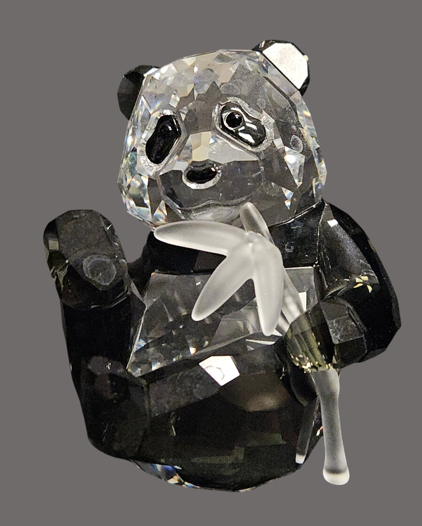 Swarovski SCS Crystal 2008 Panda Cub: 2008 SCS Annual Edition. An adorable panda made from clear and black crystal. Shown eating a frosted crystal bamboo. Swarovski swan mark. This item has its original box and paperwork. In excellent