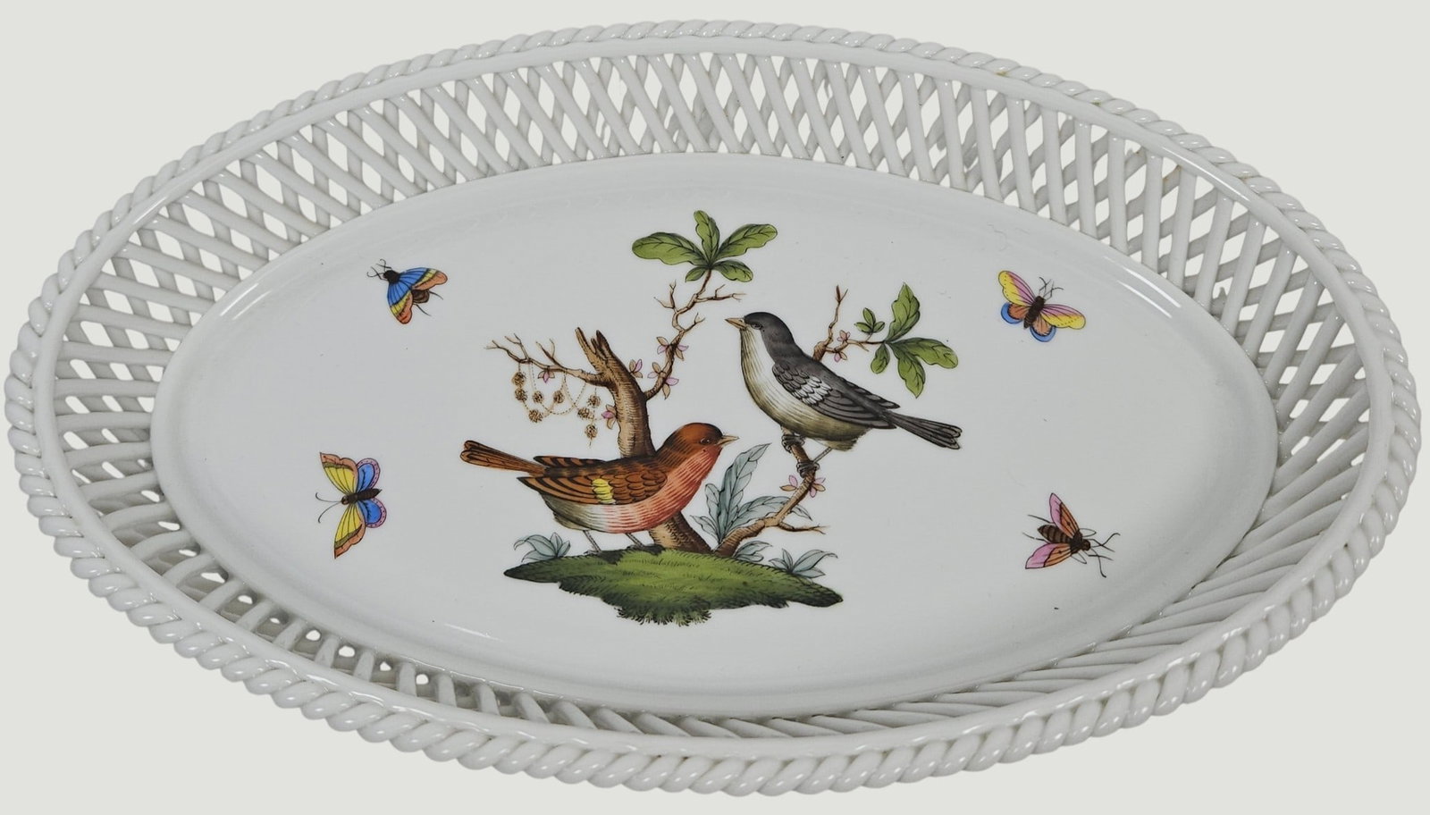 Herend Rothchild Porcelain Open Braided Oval Basket: Intricate open weave or "lattice" porcelain rim with bird and butterflies. Measures 1.5 inches high, 10.125 inches x 6.25 inches. Overall good condition, no chips or cracks.
