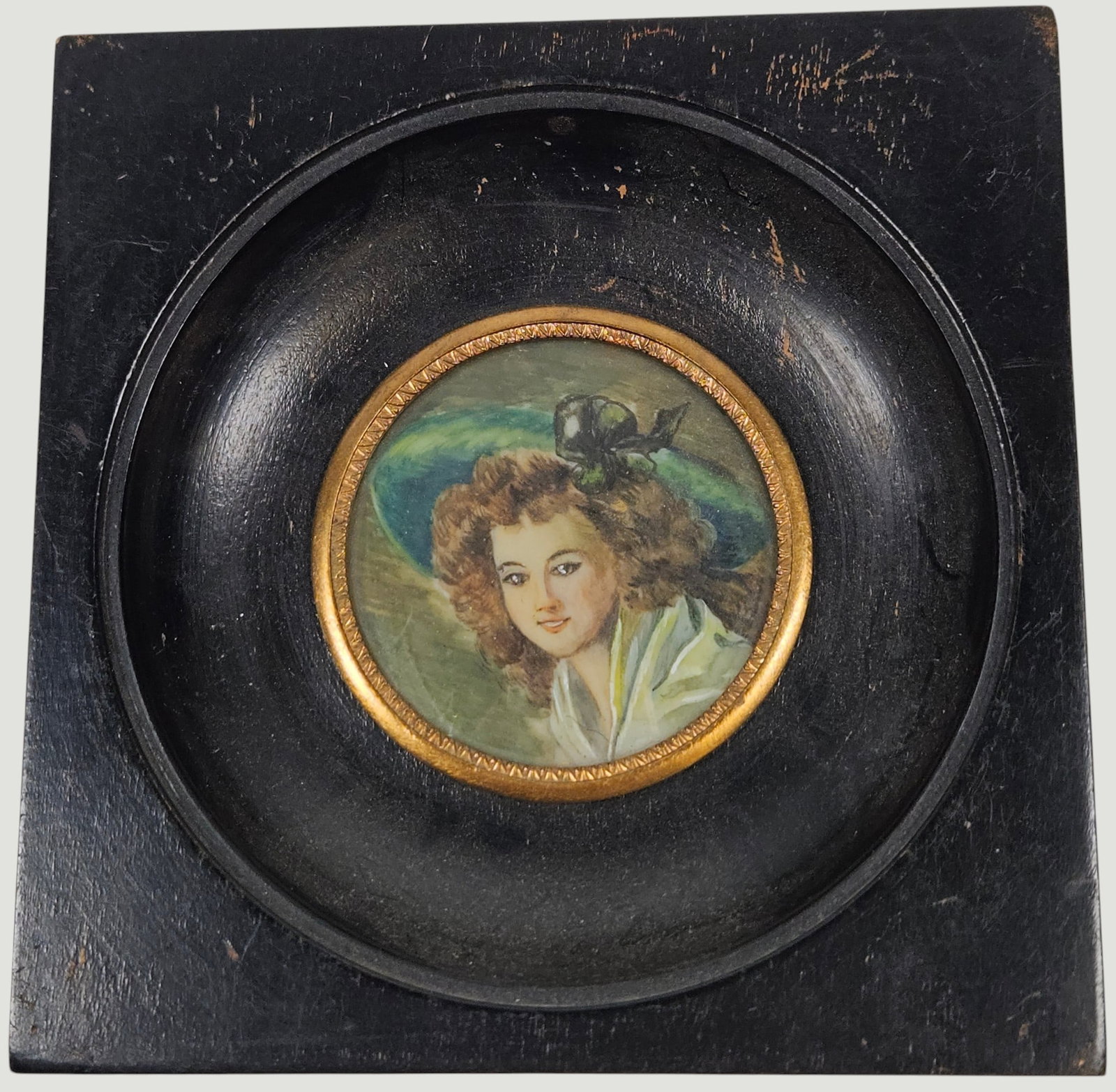 19th Century Portrait Miniature in Ebonized Wooden Frame: Circular portrait surrounded with bronze trim, housed in a square ebonized frame. Frame measures approx 4.25 inches square. No signature found. Overall good condition, please see photos.