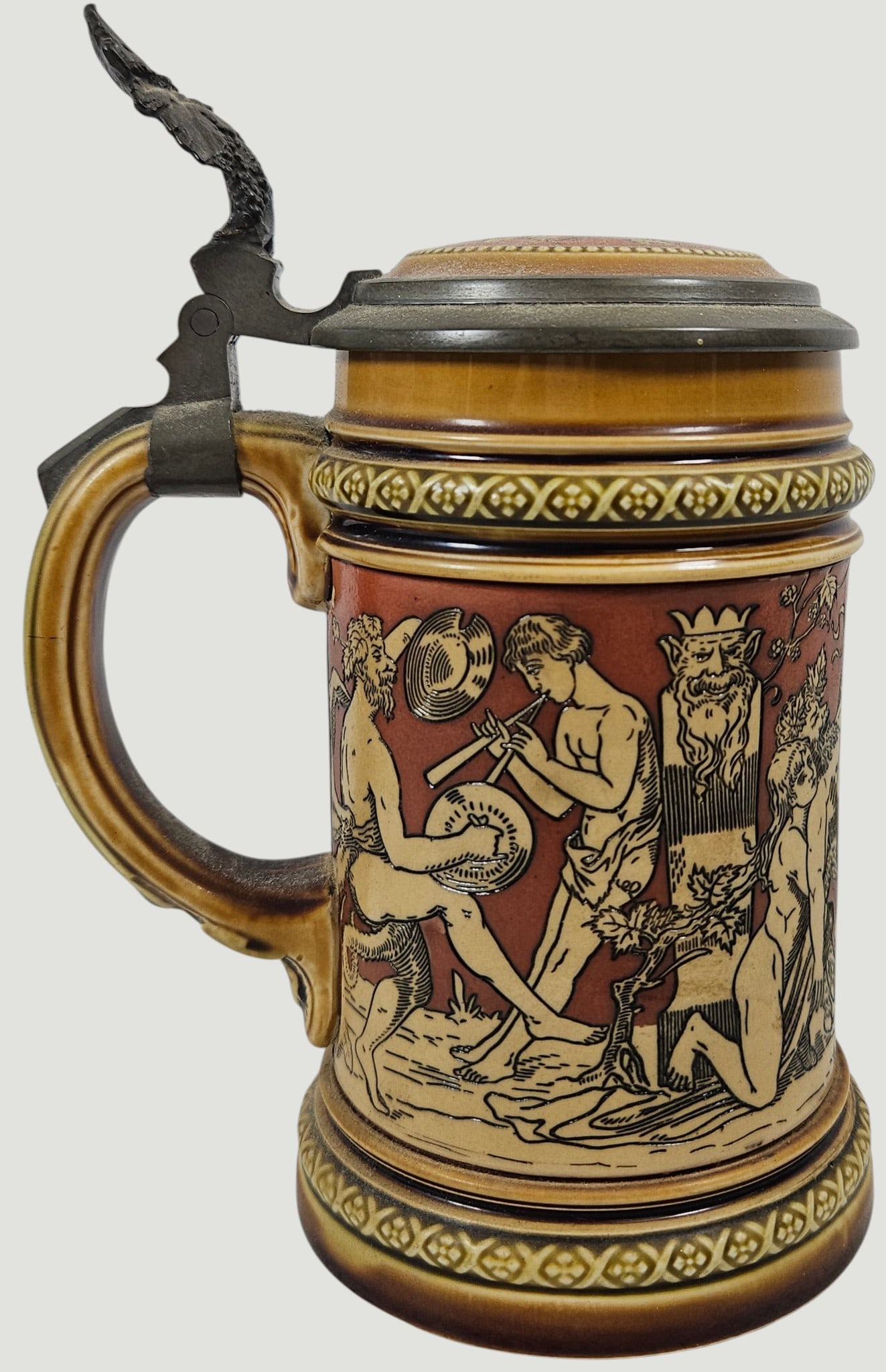 c1900 Mettlach Bacchus Procession Stein #2035: Made 1885 to 1910. Pottery, etched, 0.5L, inlaid lid. Measures 5.75 inches high to top of lid, 6.75 inches to top of metal on the lid, and 3.25 inches wide at the base. The theme of the stein is a