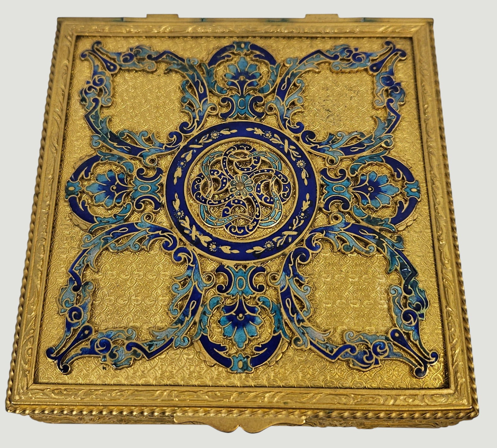 c1880 Dore Bronze & Enamel Dresser Box: Featuring intricate filigree work and shades of blue enamel details. Has a central circular medallion and for-way symmetrical filigree patterns. Box measures 1.5 inches high, 4.375 inches square.