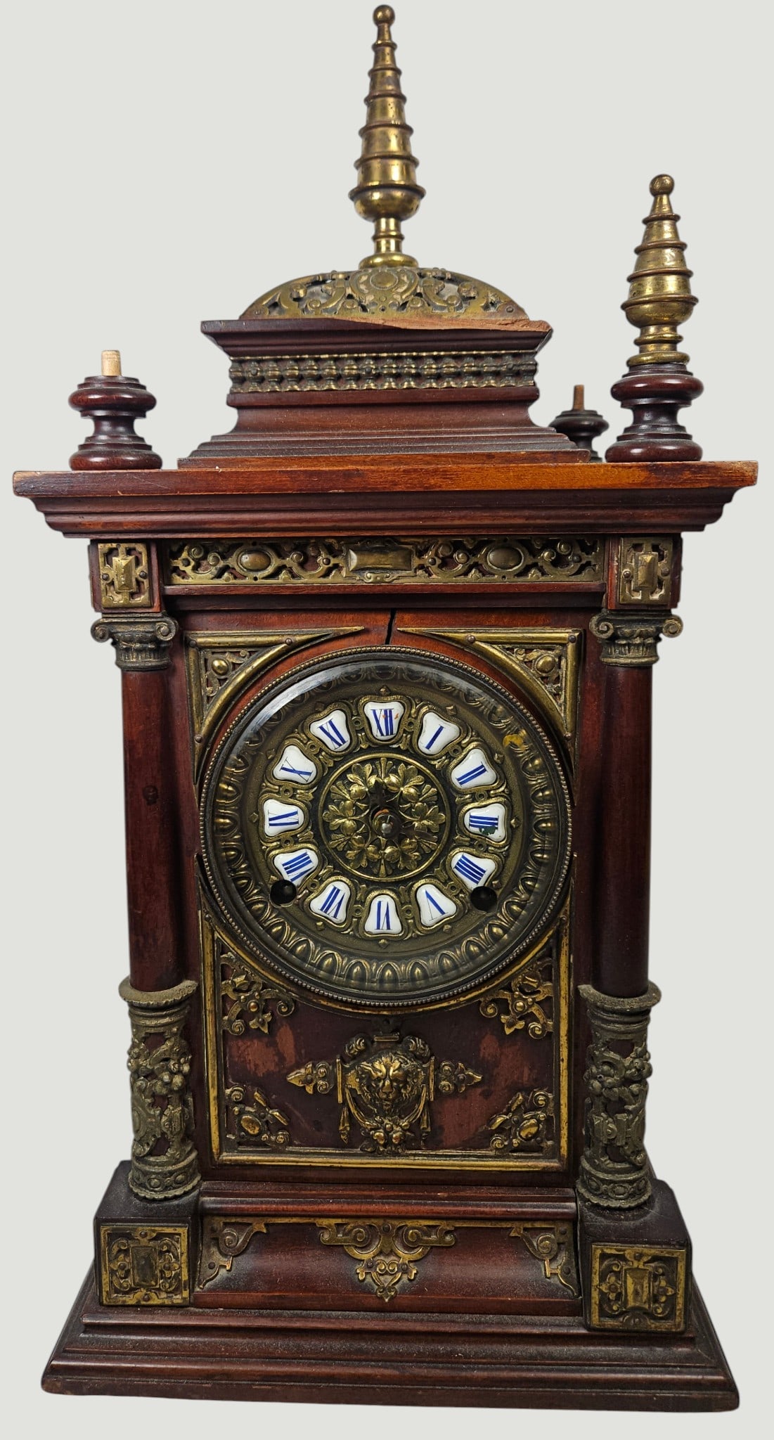 Ansonia Clock Co. "Cabinet Antique" Mahogany Mantel Clock: Ansonia Clock Co. "Cabinet Antique" Mahogany Mantel Clock, late 19th century. The mahogany case with a domical top with brass spire finials (missing 3 of the 5 finials) and applied brass mounts throug