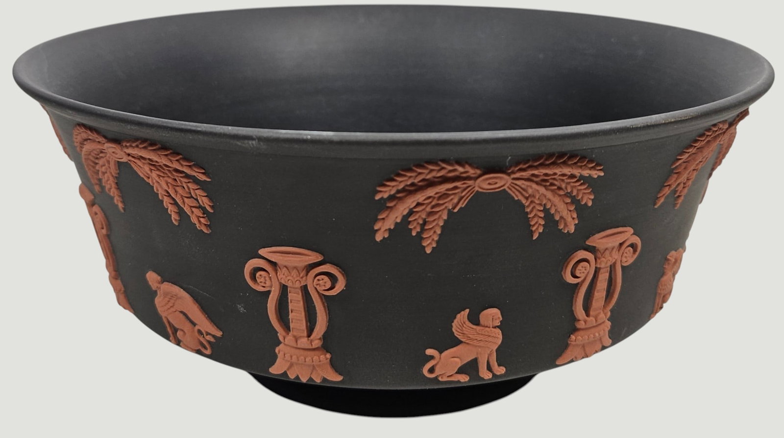 Wedgwood Terracotta On Black Jasperware Egyptian Round Nile Bowl: Rare, impressed matte black bowl with the Egyptian pattern in relief in terracotta jasperware. Wedgwood impressed backstamp. Measures 3.5 inches high, 8 inch diameter across the top. Overall good