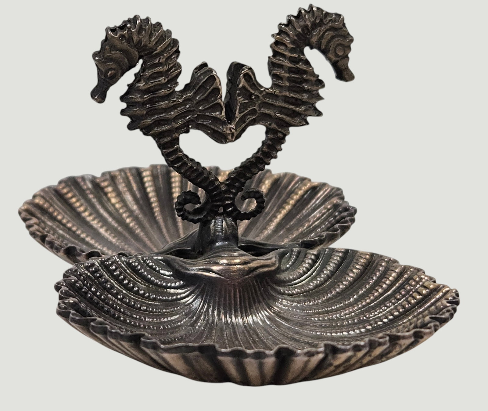 Sterling Buccellati Seahorse Salt & Pepper Sea Jewels Collection: Two meticulously handcrafted silver shells joined by a pair of seahorses, which act as the handle. Signed on the bottom. Comes with original box and ribbon. Measures 1.5 inches high, 3 inches x 1.875