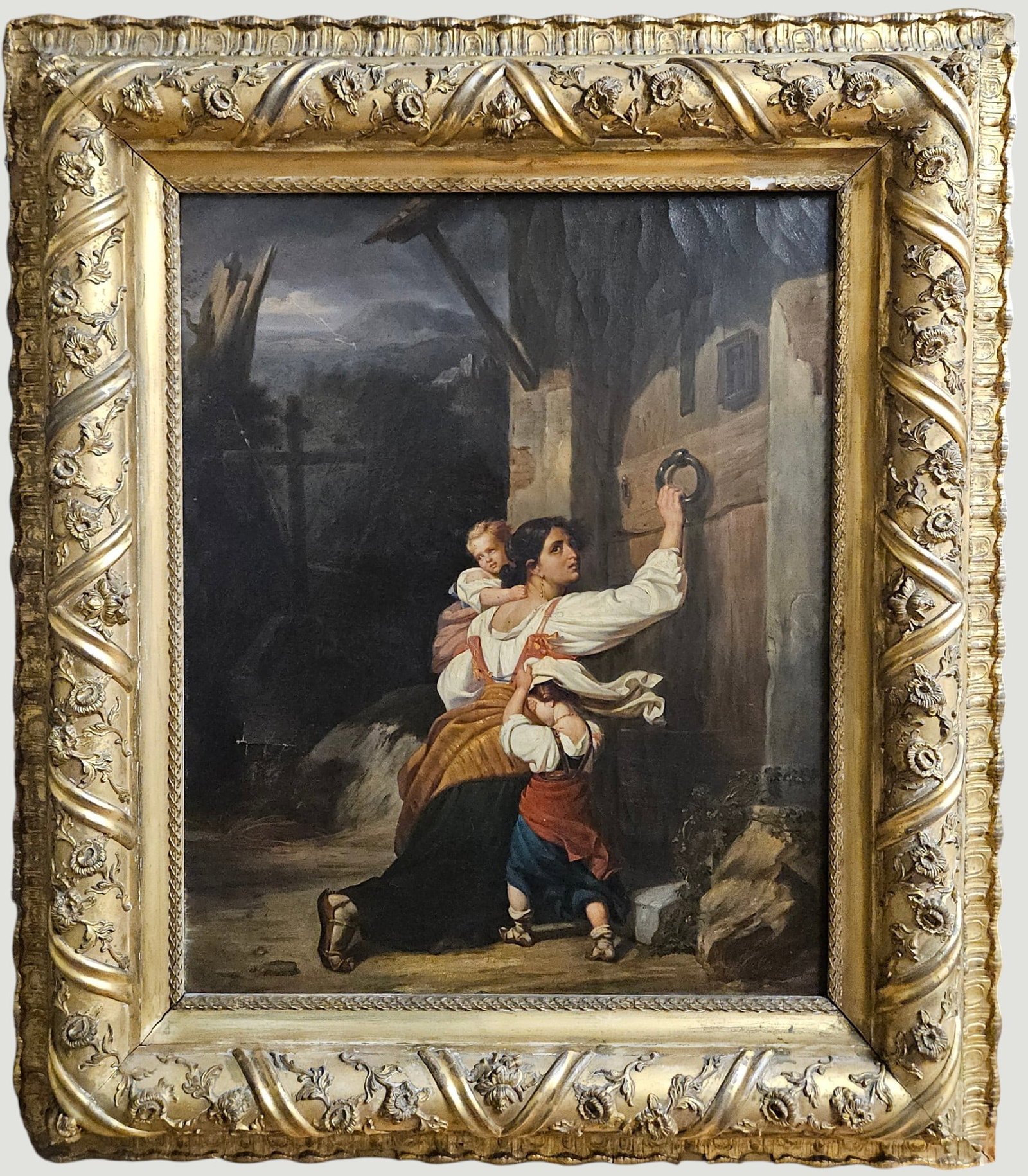 19C After Giuseppe Mazzolini (Italian 1806-1878) Oil on Canvas 'Mother & Children Fleeing': Scene depicts a woman bending on one knee at a doorway, with a child in her arms looking back while another child hides their face against her skirt. In the background,a cross strands near a wooden pa