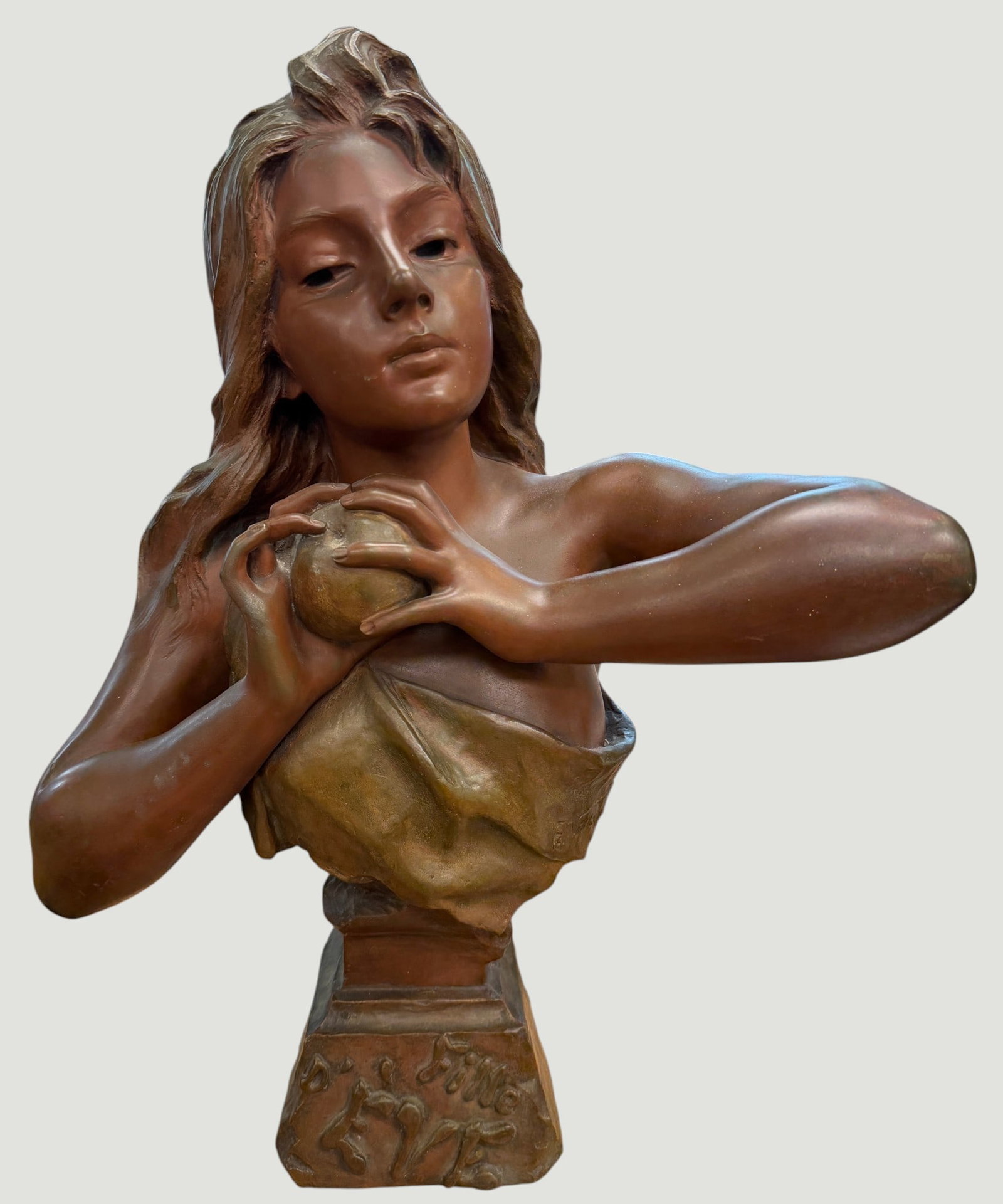 Emmanuel Villanis (French, 1858-1914) Bronze 'Fille D'Ève': A stunning late 19th Century French Art Nouveau bronze bust of a beautiful young woman holding an apple representing the Biblical character of 'Eve', partly clothed in elegant classical attire with lo