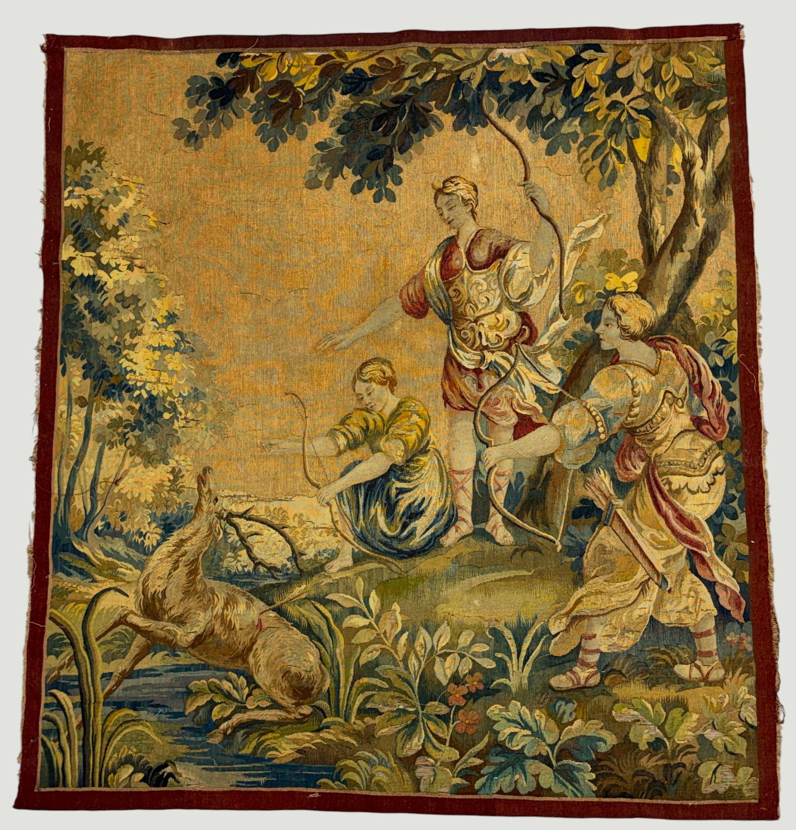 19th Century French Rococo Style Hunting Scene Tapestry: Depicts figures dressed in classical attire hunting a stag in a dense forest landscape. Measures 56 x 51 inches. Overall good/fair condition. Tears and rips, please see photos.