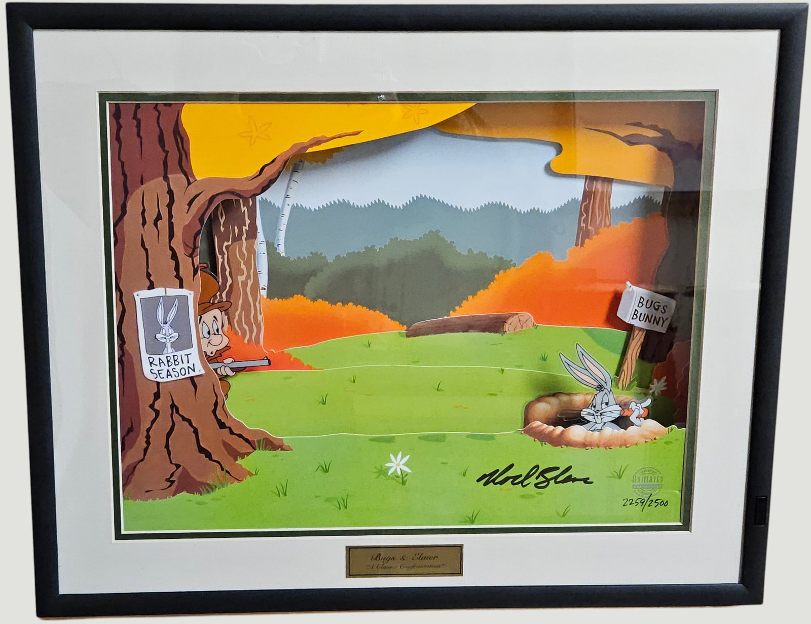 Warner Brothers Mel Blanc Signed Animation Cel Bugs Bunny and Elmer: An animation cel featuring Bugs Bunny and Elmer Fudd titled "A Classic Confrontation" from the Warner Brothers. This piece features a diorama with the cartoon characters on acetate and moving parts.