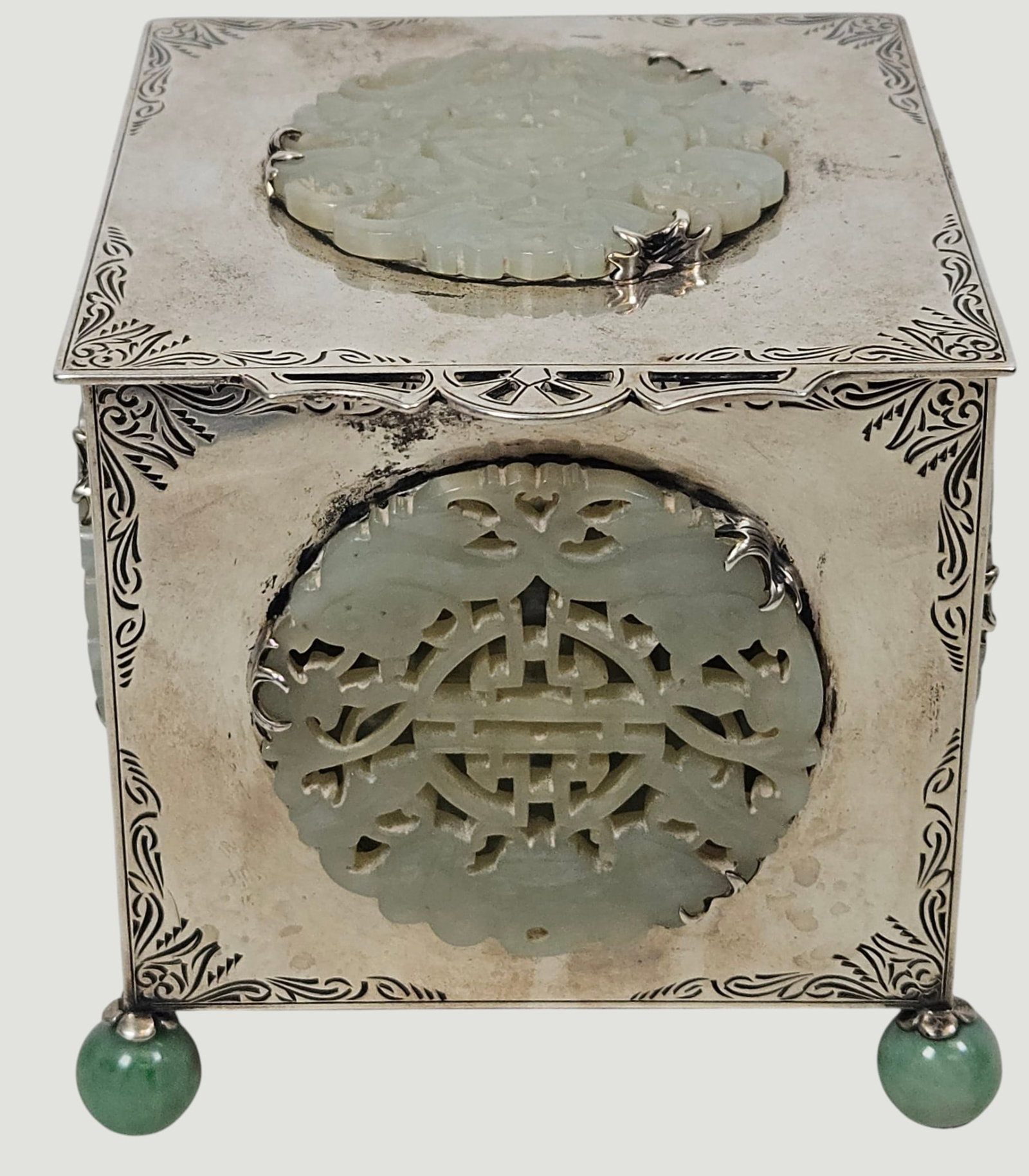 Ming Dynasty Edward J Farmer Chinese Silver & Pale Celadon Jade Box: Cubic framework is constrictged from etched sterling silver decorated with chased corner scrollwork, inset with multiple openwork circular celadon jade plaques. It stands on 4 spheres (3 jade and 1