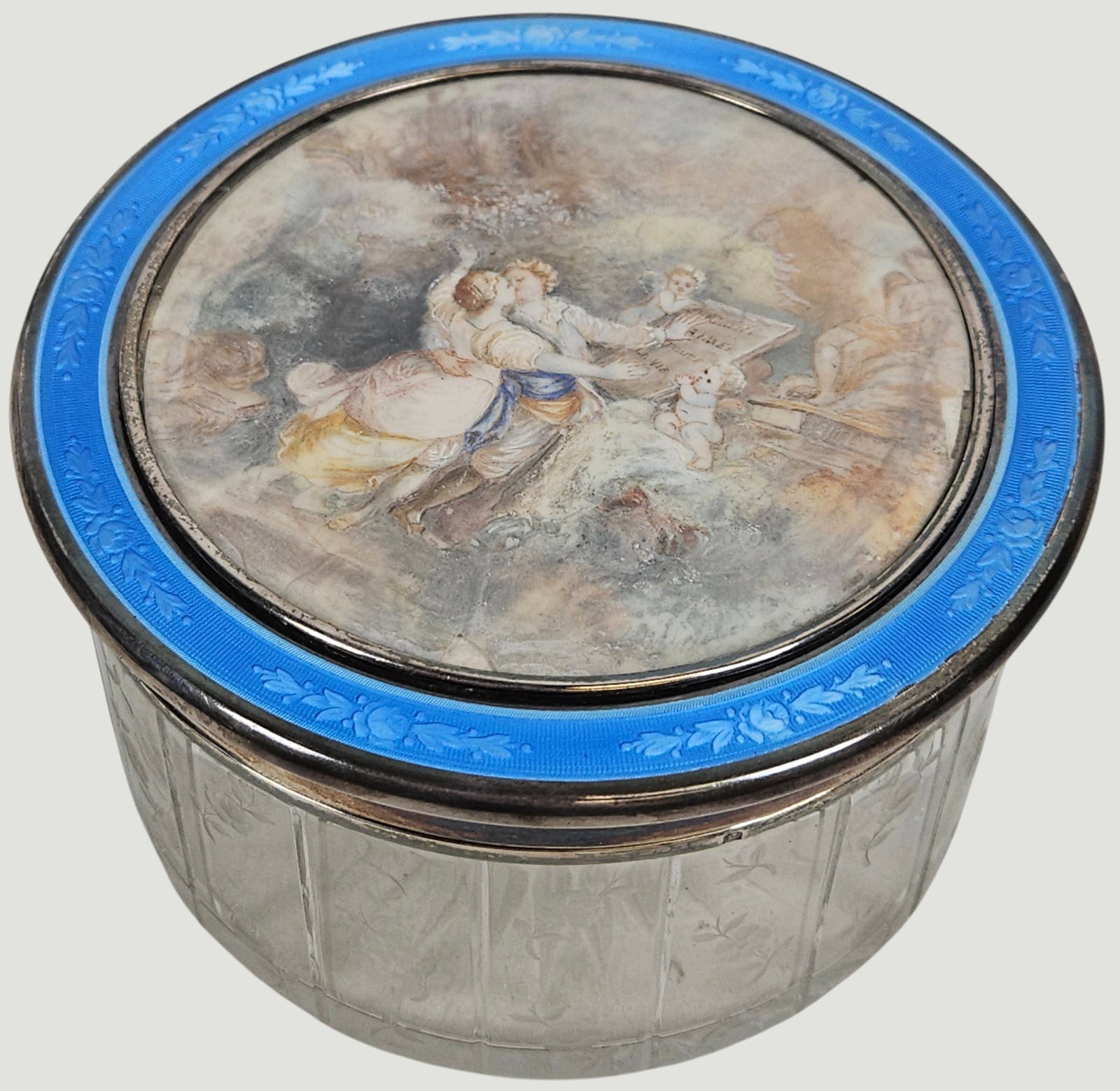 Large 19th Century French Sterling Silver & Enamel Dresser Box w/ Fête Galante: The miniature artwork on the top of the dresser box depicts a couple in Rococo style period clothing sharing an embrace next to a classical monument flanked by cherubs. Outer rim is blue enamel with