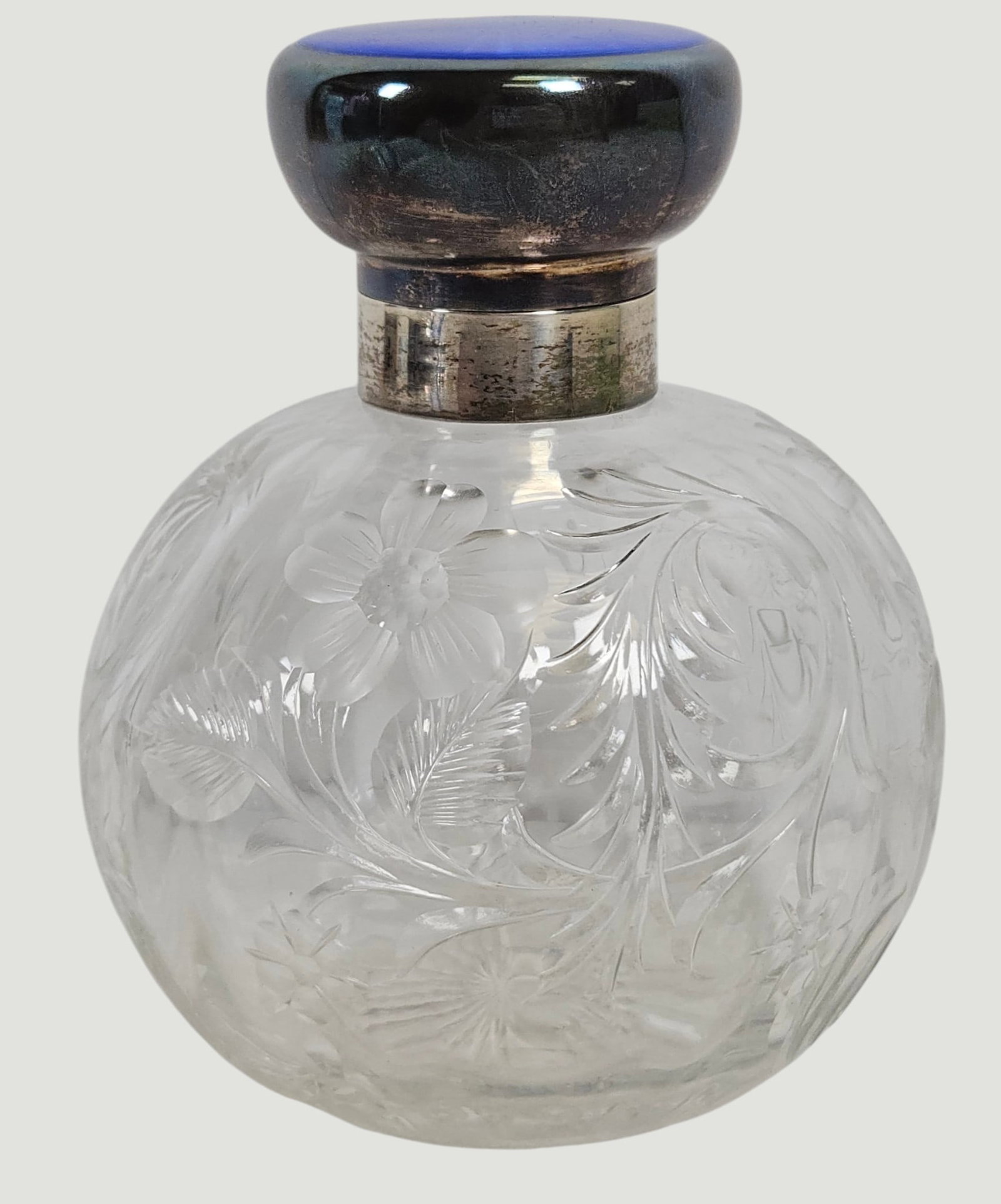 c1921 London England Sterling Silver & Blue Enamel Crystal Perfume Bottle: Etched glass with flowers, cobalt blue enamel top over sterling silver. Dated 1921, maker Charles Henry Dumenil. Bottle measures 5 inches high, 4 inches at its widest. Includes original stopper.