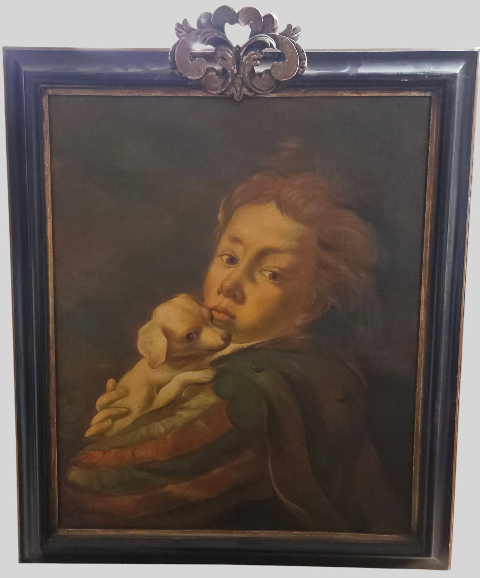 19th Century Oil on Canvas Portrait of a Child with Little Dog: Featuring classic chiaroscuro lighting and rich, earthy tonal values. Depicts a young child with strawberry blonde hair wearing a green cloak and a striped garment, tenderly cradling a small puppy. Si