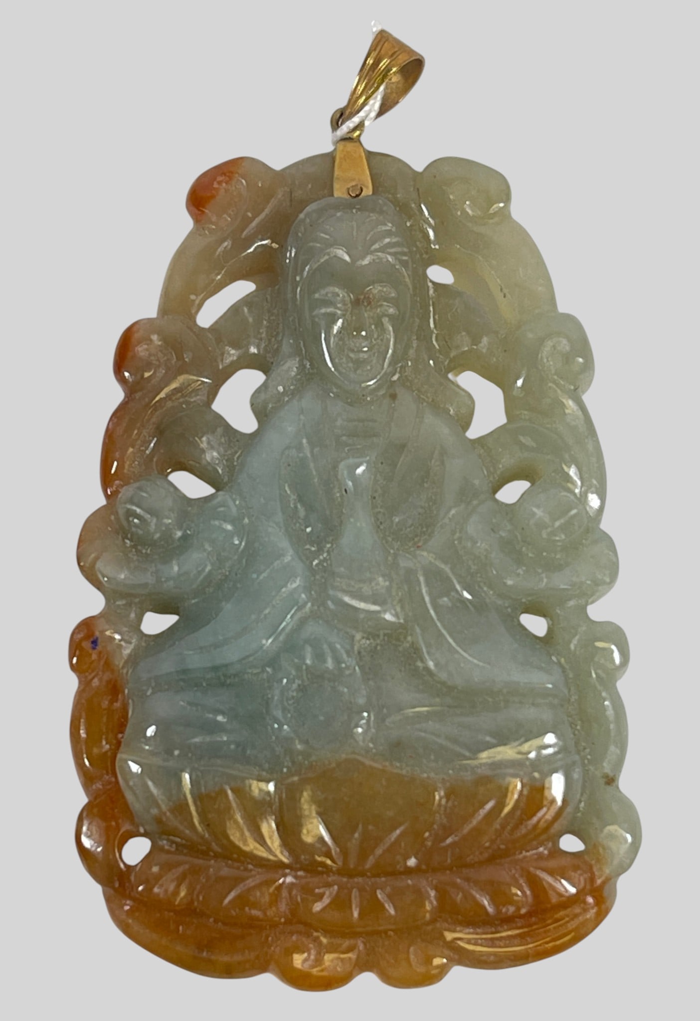 Chinese Hand Carved Multi Color Jade Guanyin Pendant w/ 14k Yellow Gold Bale: A beautifully detailed vintage Chinese carved jadeite jade pendant depicting Guanyin (Kwan Yin). The striking openwork carving presents a serene figure seated in a meditative posture atop a stylized
