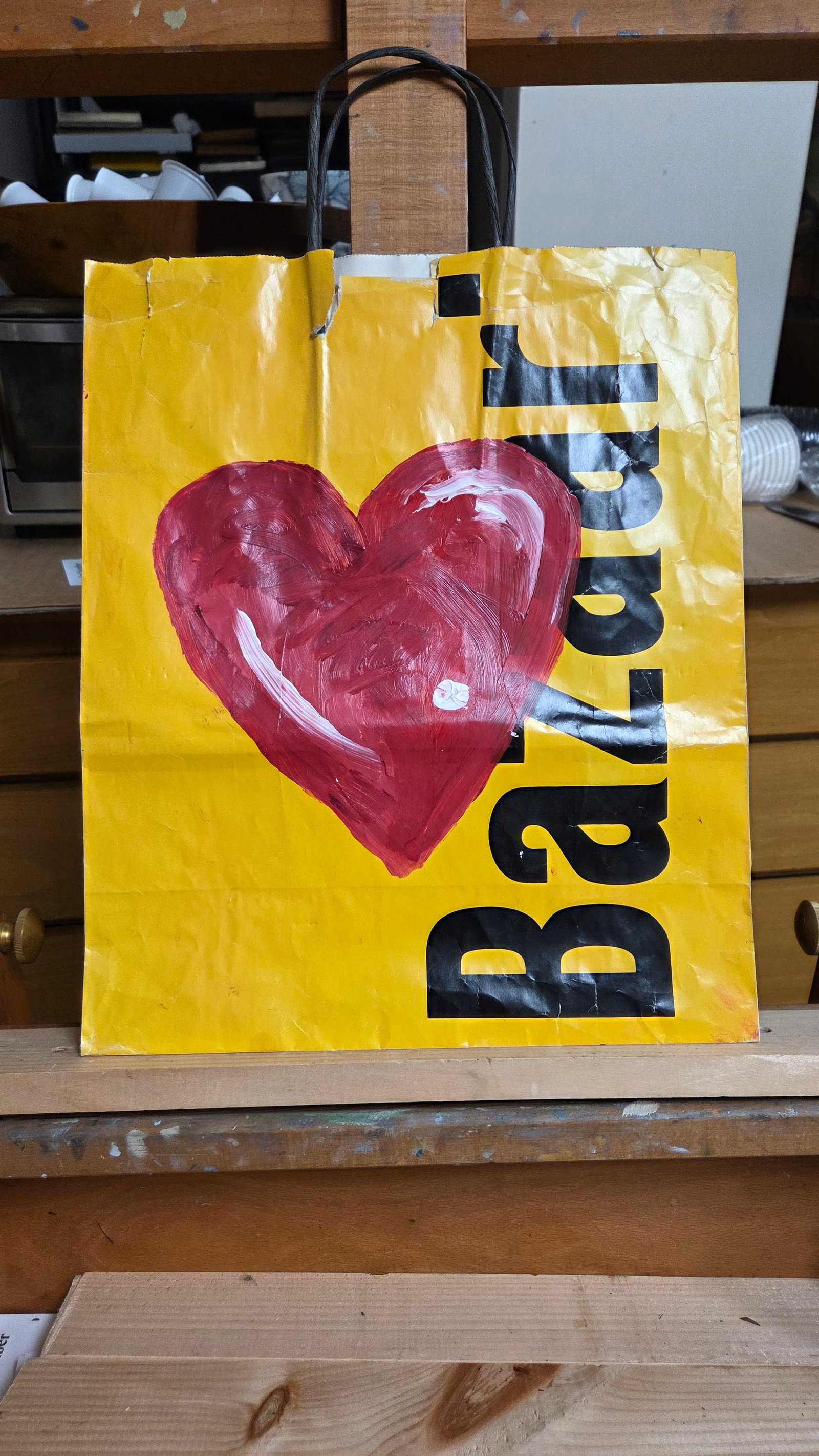 Attb Jim Dine Pop Art Oil on Paper Shopping Bag Robert Buecker Estate: Red heart painted on a Bazaar shopping bag, attributed to Jim Dine. Bag measures 13 inches wide, 15.5 inches high without handle. Overall good condition, some tears to the bag. Please see photos. Prov