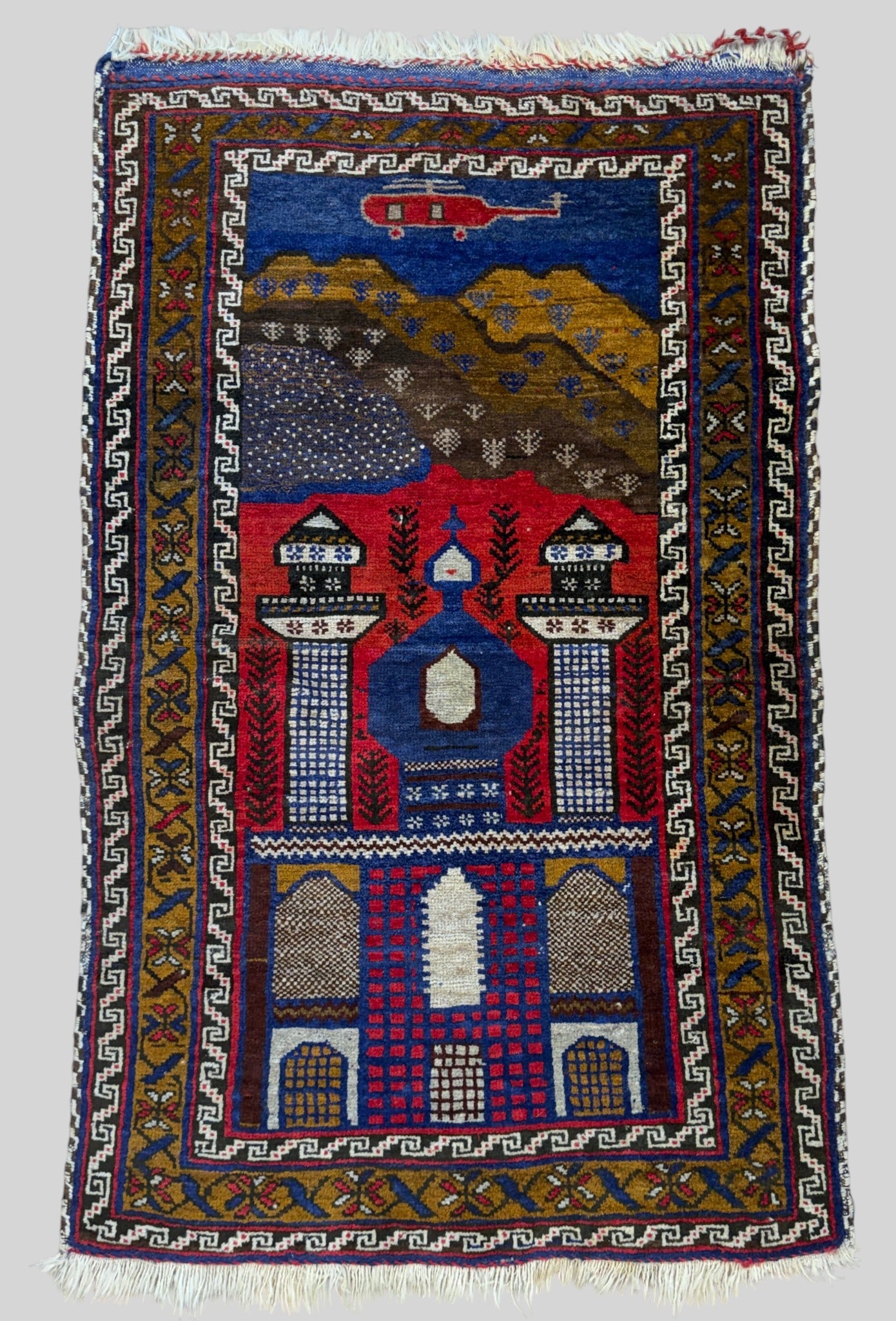 Hand Knotted Afghan Baluch Pictoral 'War' Rug: This exceptional and highly collectible Afghan Baluch pictorial "war rug" features a masterfully hand-knotted composition that subverts a classical architectural prayer layout with contemporary milita