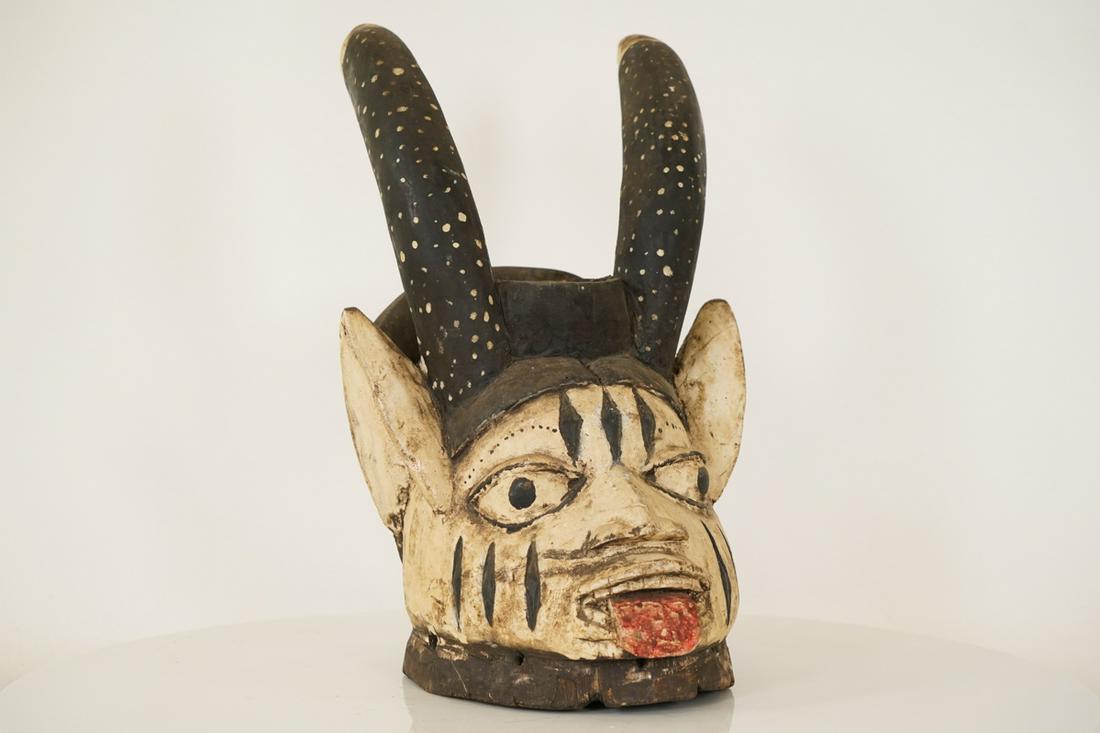 Yoruba Mask from Nigeria - African Tribal Art: Measurements (inches) & Weight (pounds) Height: 16" Width: 9.5" Depth: 11" Weight: 2.5 lbs A fascinating Yoruba mask with two horns, exaggerated ears and an outstretched tongue.