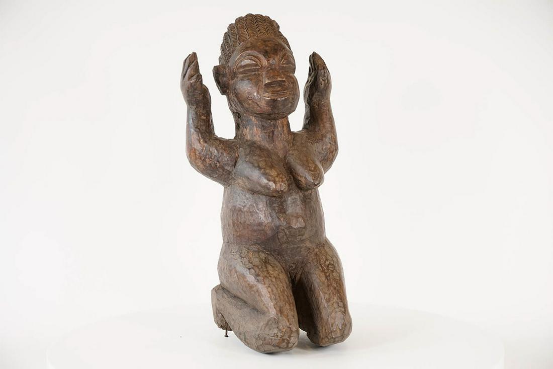 Yoruba Kneeling Female Figure - Nigeria - African Tribal Art Sculpture: Measurements (inches) & Weight (pounds) Height: 17.5" Width: 8.5" Depth: 8" Weight: 7.5 lbs A gorgeous kneeling female figure with her hands raised above her head.