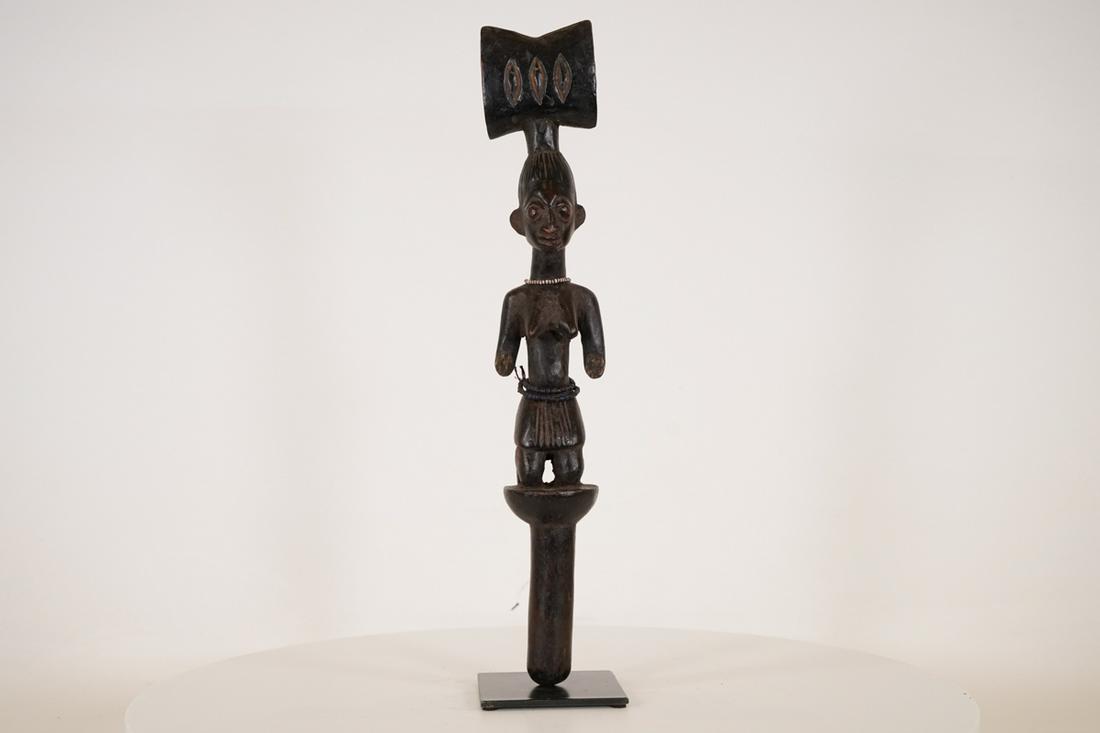 Yoruba Shango Figure on Base - Nigeria - African Tribal Art Sculpture: Measurements (inches) & Weight (pounds) Height: 19.5" Width: 3.25" Depth: 2.5" Weight: 2 lbs A gorgeous Shango staff with a beaded necklace around neck and abdomen and secured to metal base.